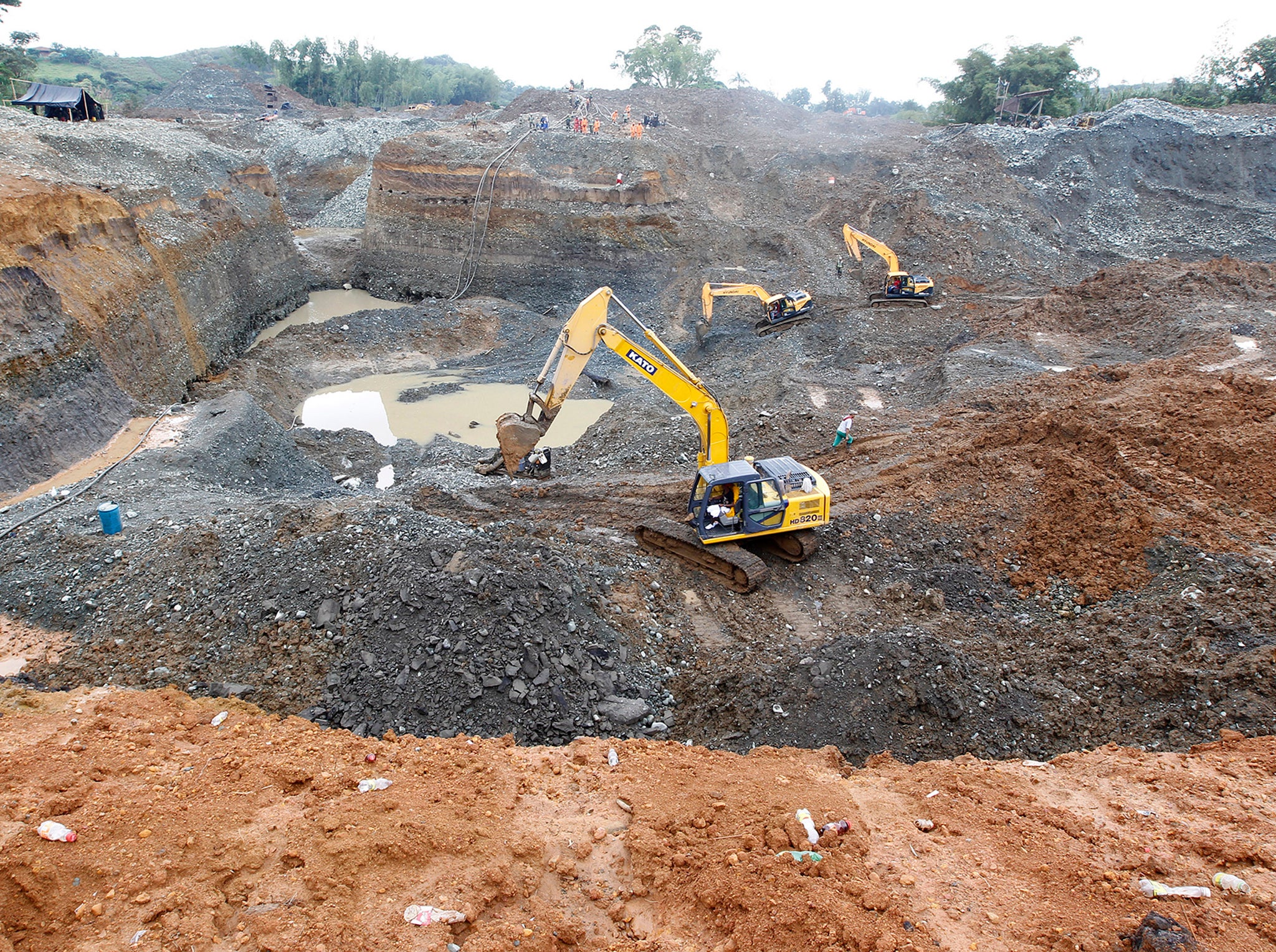 Rescue workers search for the bodies of miners, who were working in an illegal gold mine when it collapsed, in southern Colombia