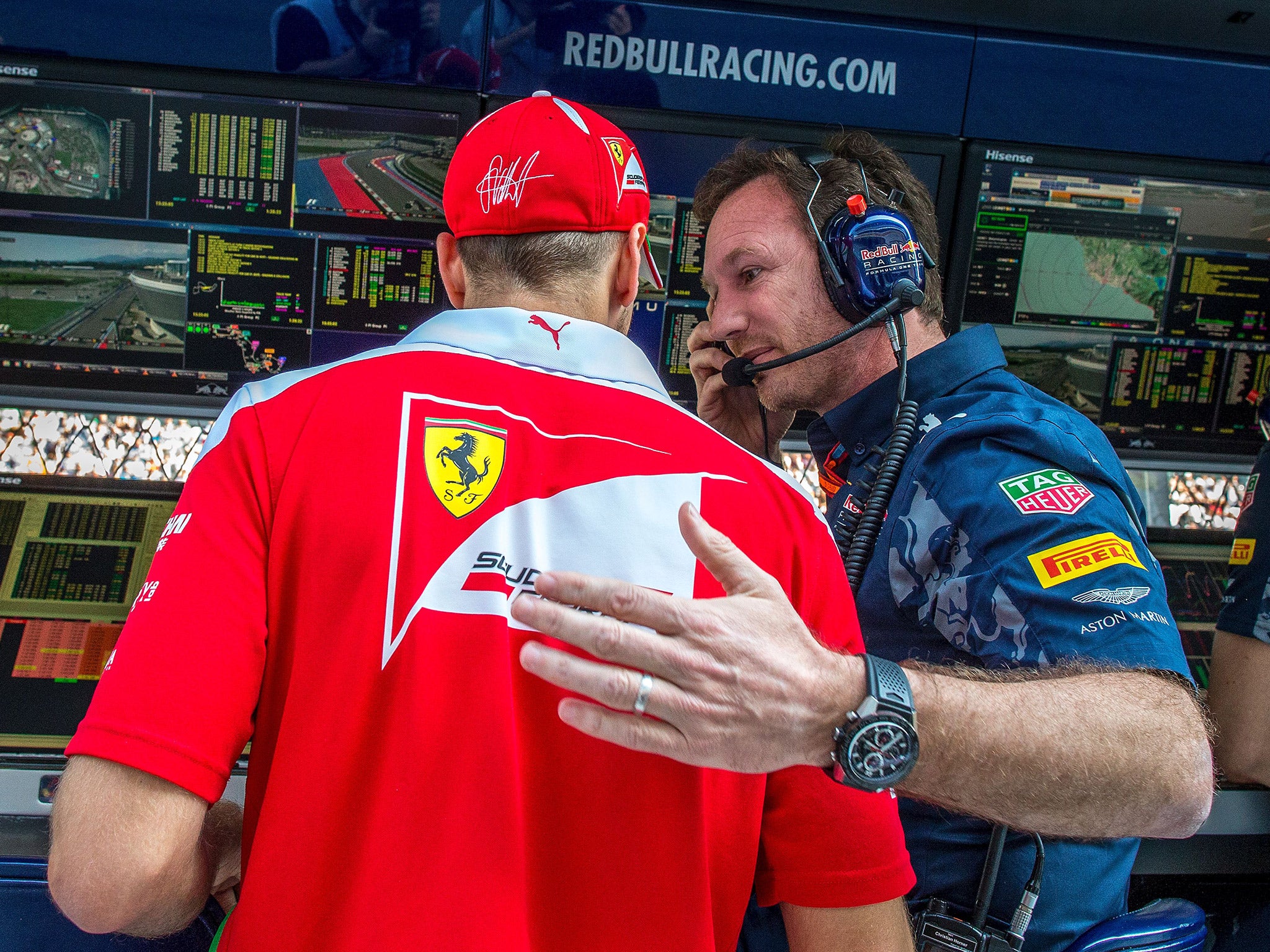 Sebastian Vettel speaks with Christian Horner after being taken out by Daniil Kvyat