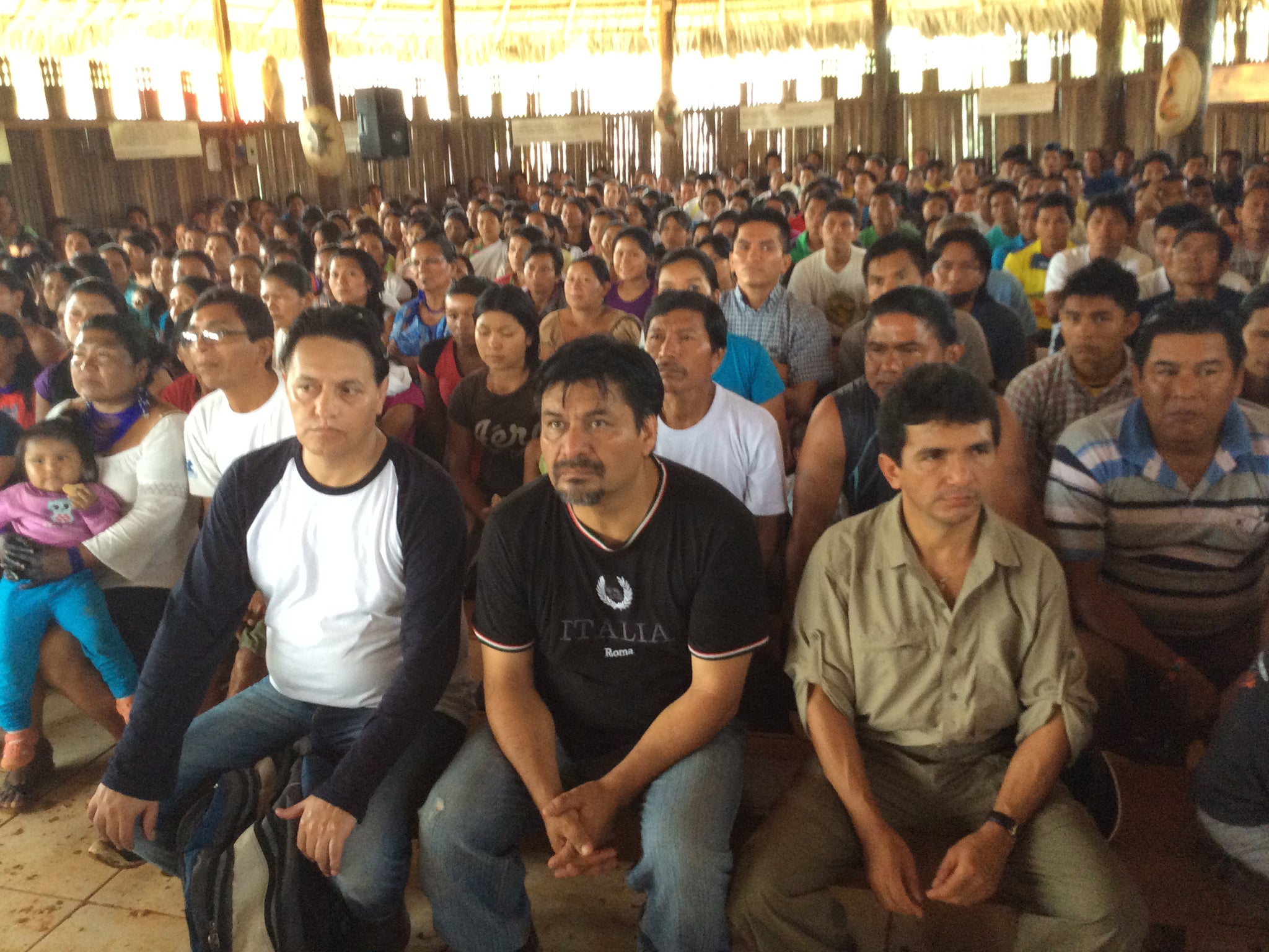 Fernando Villavicencio (left) attends a Sarayaku meeting after the journalist was taken in by the Kichwa people