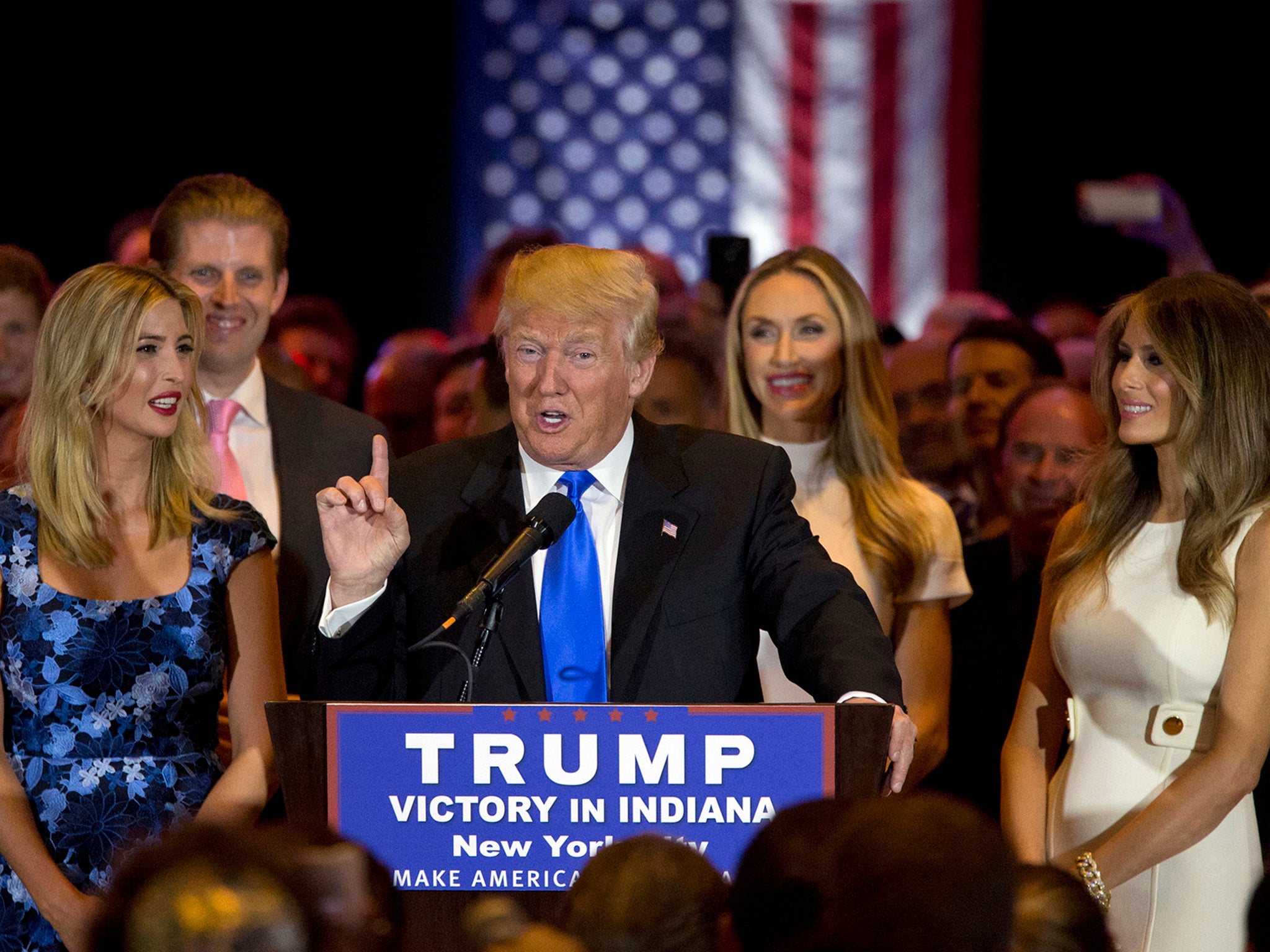 Donald Trump joined by his wife Melania, right, daughter Ivanka, left, and son Eric, background left, as he speaks during news conference after his Indiana win