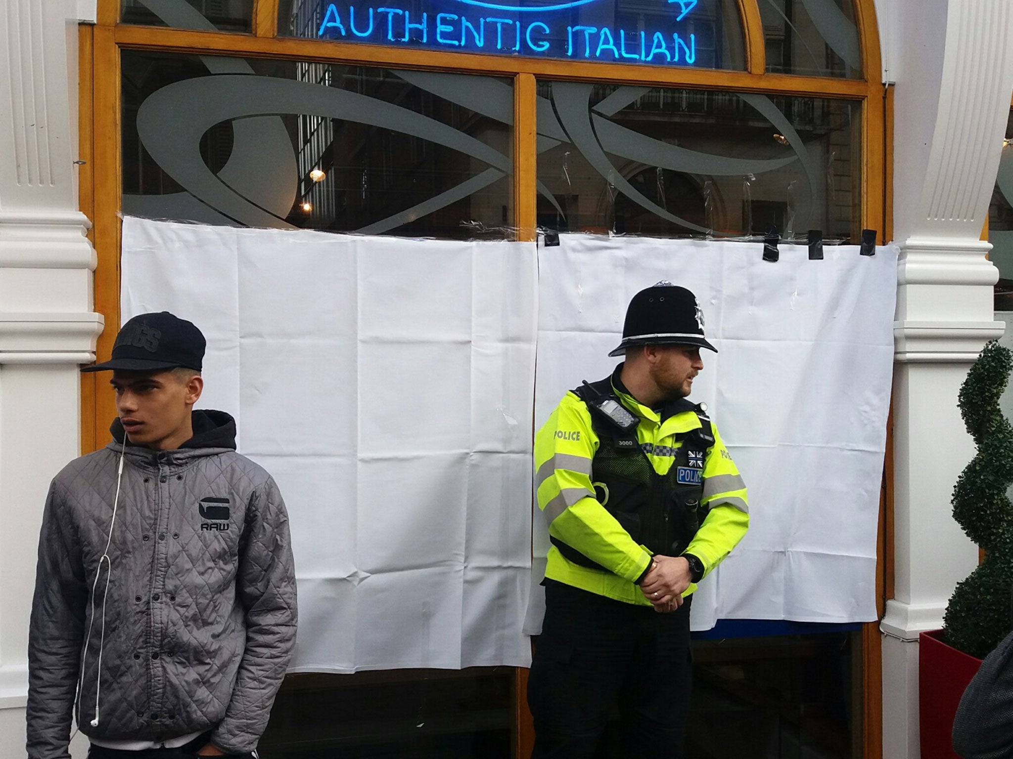 Police guard the restaurant