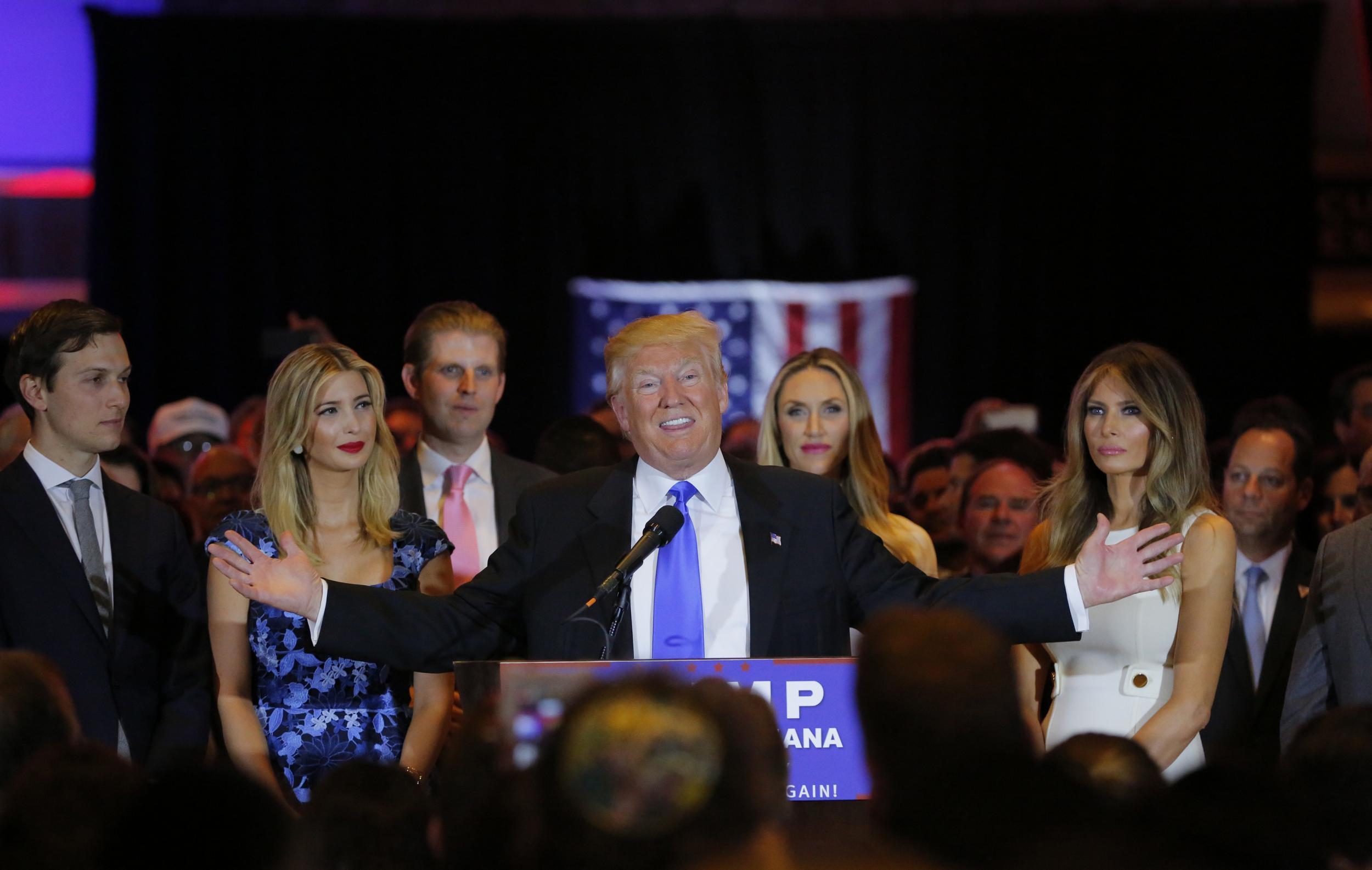 Republican US presidential candidate Donald Trump speaks, alongside his son-in-law, daughter and wife