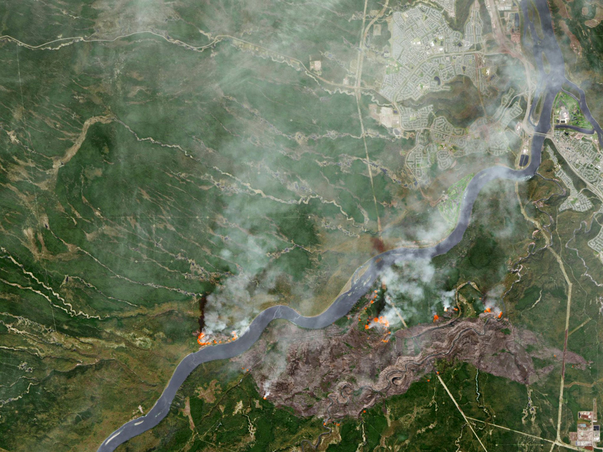 NASA's Earth Observatory image of destructive wildfires burning through the Northern region of Alberta