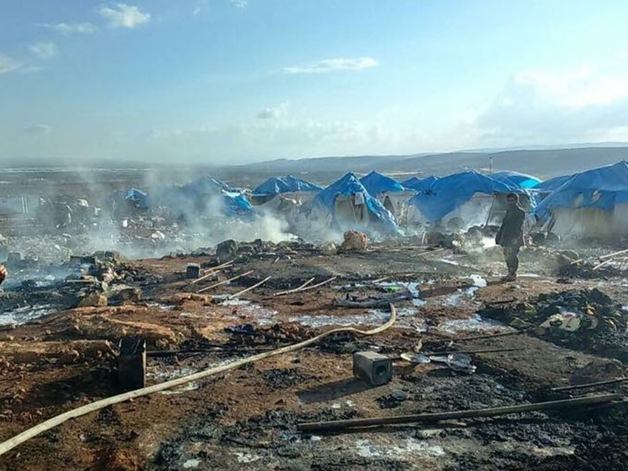 The scene shortly after the air strike on Thursday afternoon in Sarmada, near the border with Turkey