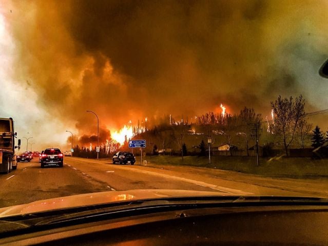 Residents escape the flames engulfing Fort McMurray, Canada, earlier this year