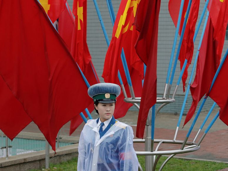 A policewoman controls the traffic near the venue of the Workers' Party of Korea (WPK) congress in Pyongyang, North Korea