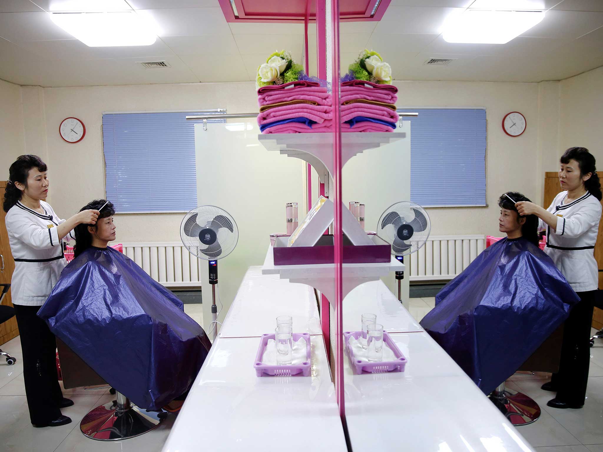 A woman is having her hair done during a government-organised visit for foreign reporters to the Pyongyang 326 Electric Cable Factory in Pyongyang, North Korea