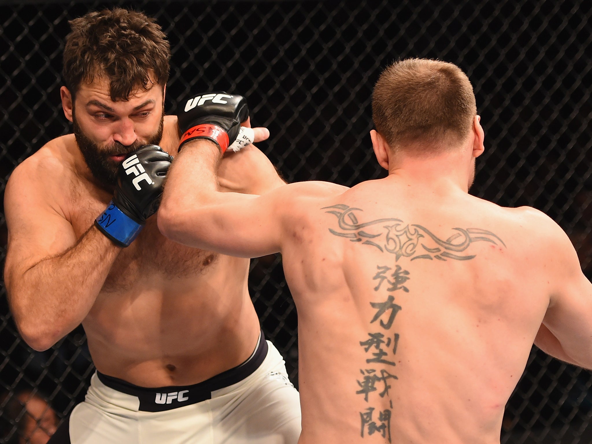 &#13;
Stipe Miocic (right) connects with Andrei Arlovski &#13;