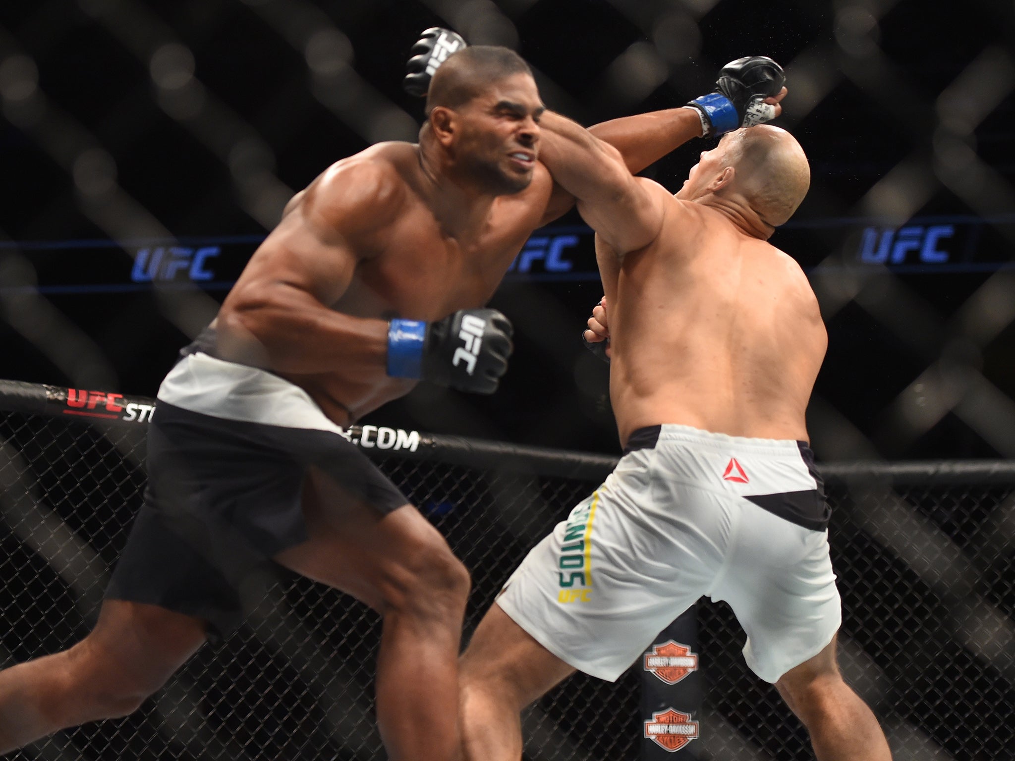 Alistair Overeem lands a blow on Junior Dos Santos