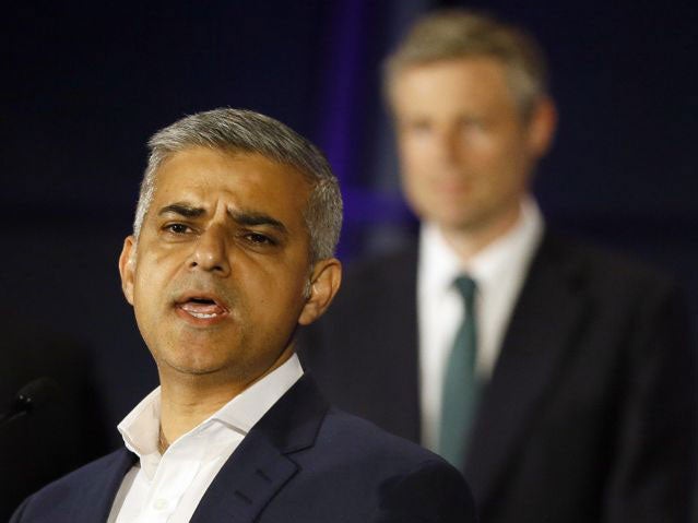 Zac Goldsmith listens at City Hall as Sadiq Khan gives his victory speech, calling for "hope over fear and unity over division"