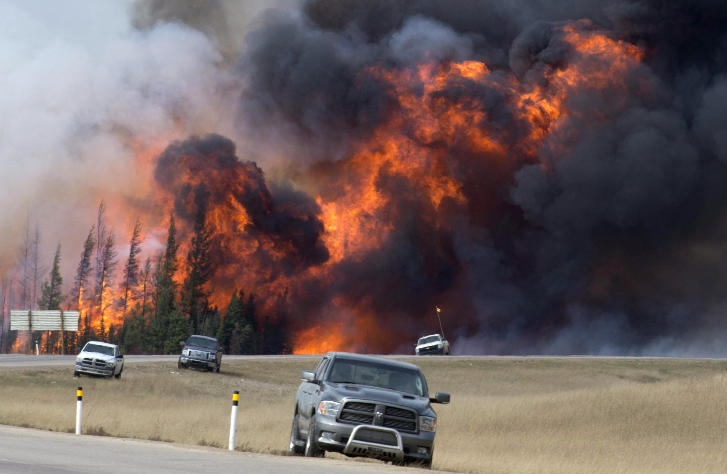 A wildfire burns south of Fort McMurray, Alberta, near Highway 63 on Saturday, May 7, 2016