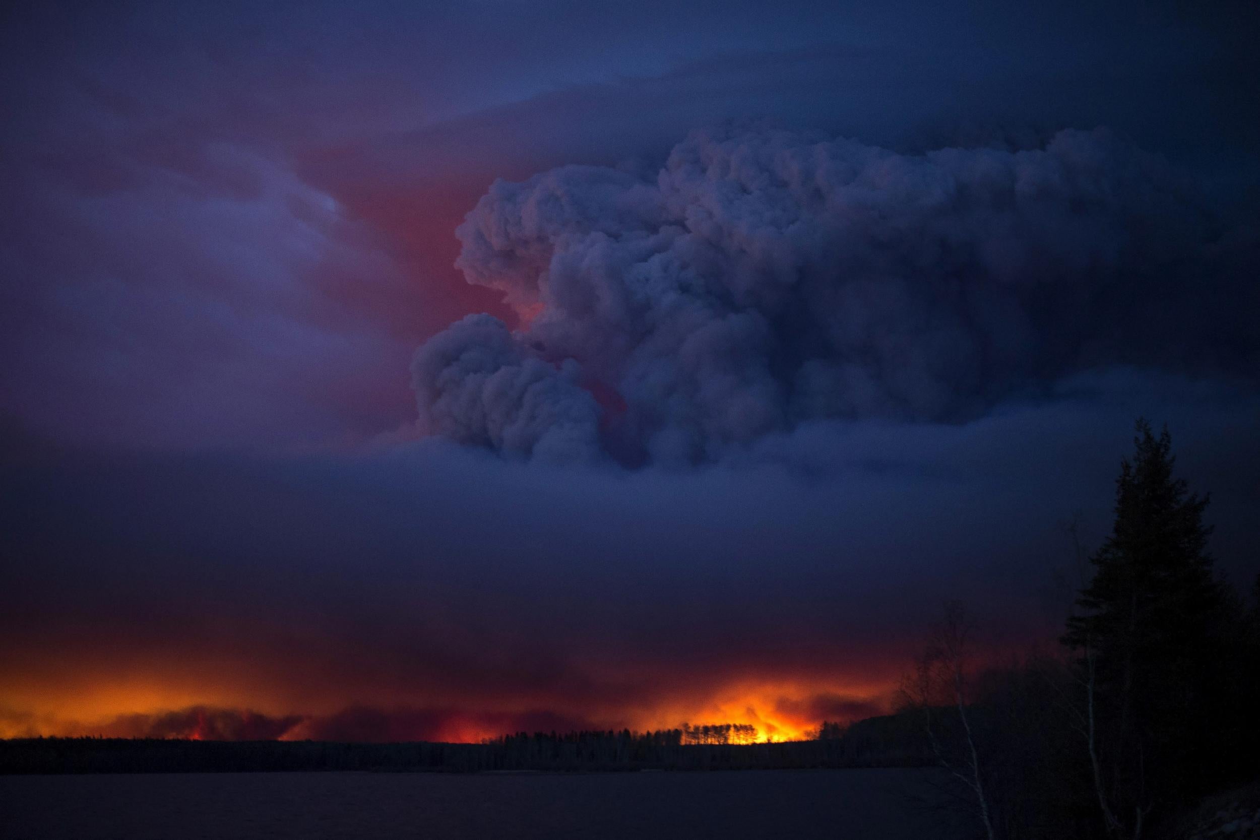 A massive wildfire raging near Anzac, a hamlet 48 km southwest of Fort McMurray, Alberta,