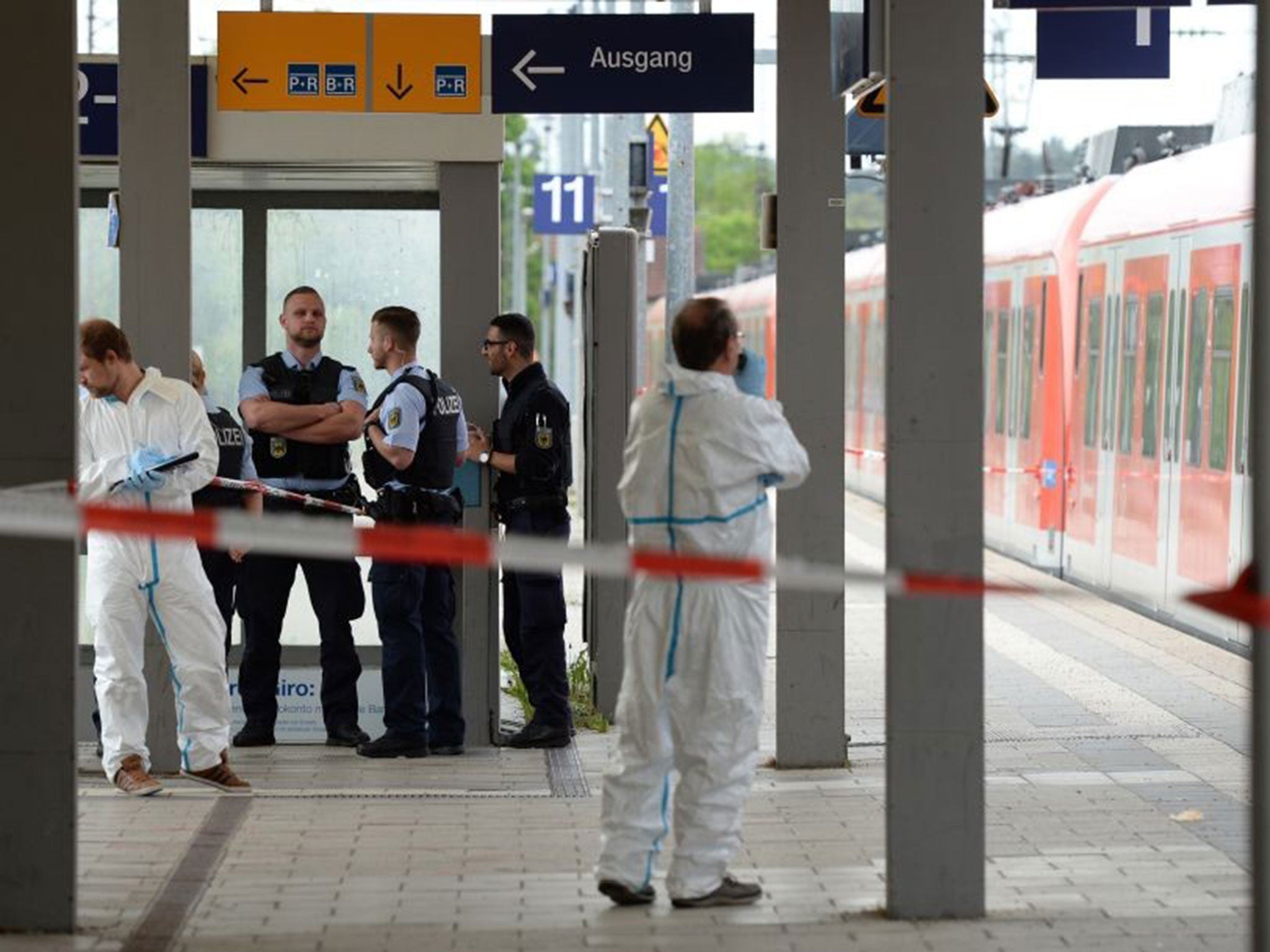 Forensic investigators at the scene of a stabbing attack on a train at Grafing railway station near Munich, Germany, 10 May 2016.