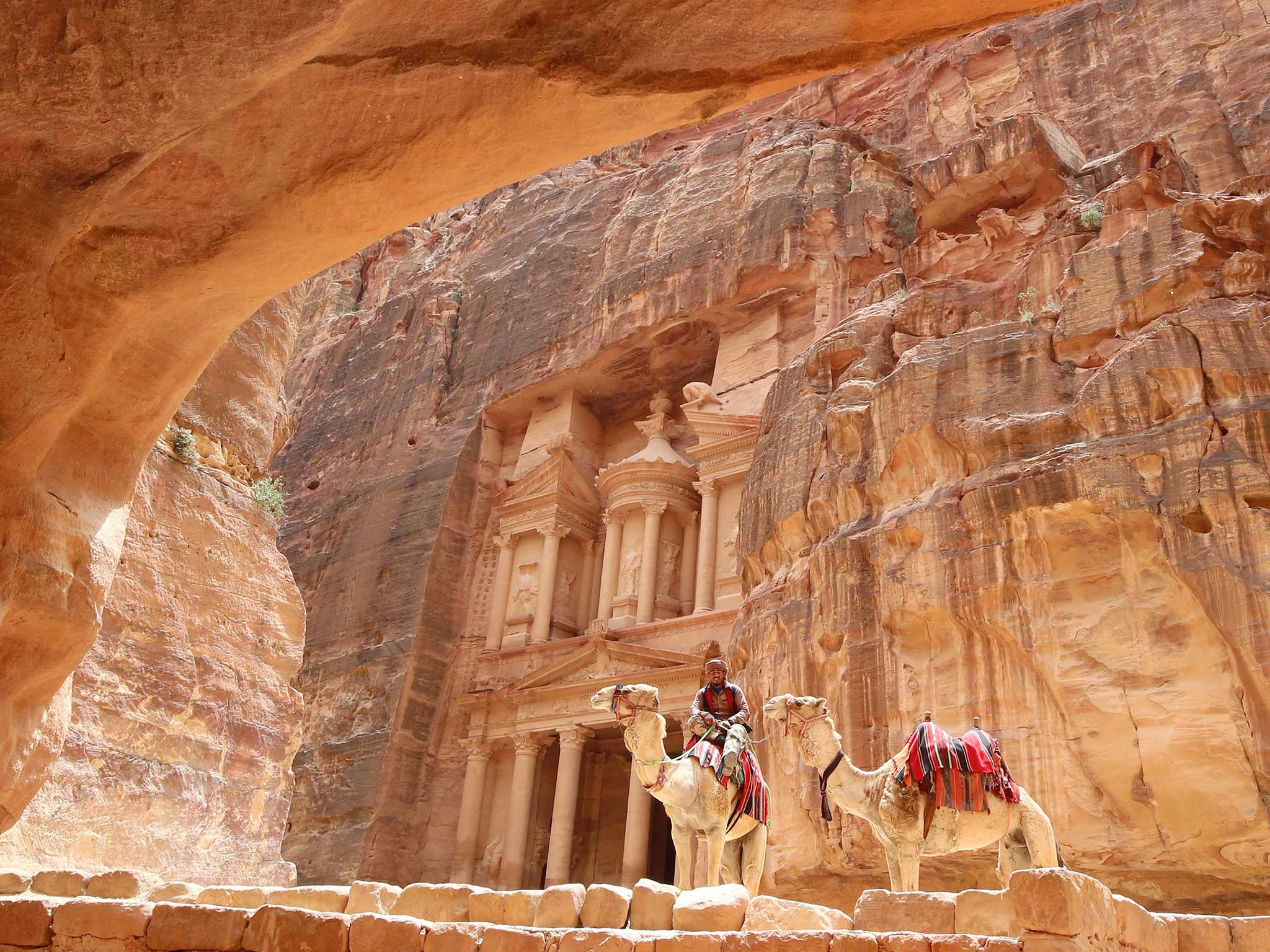 A Jordanian Bedouin sits on a camel in front of the Treasury Building in the ancient city of Petra in Jordan