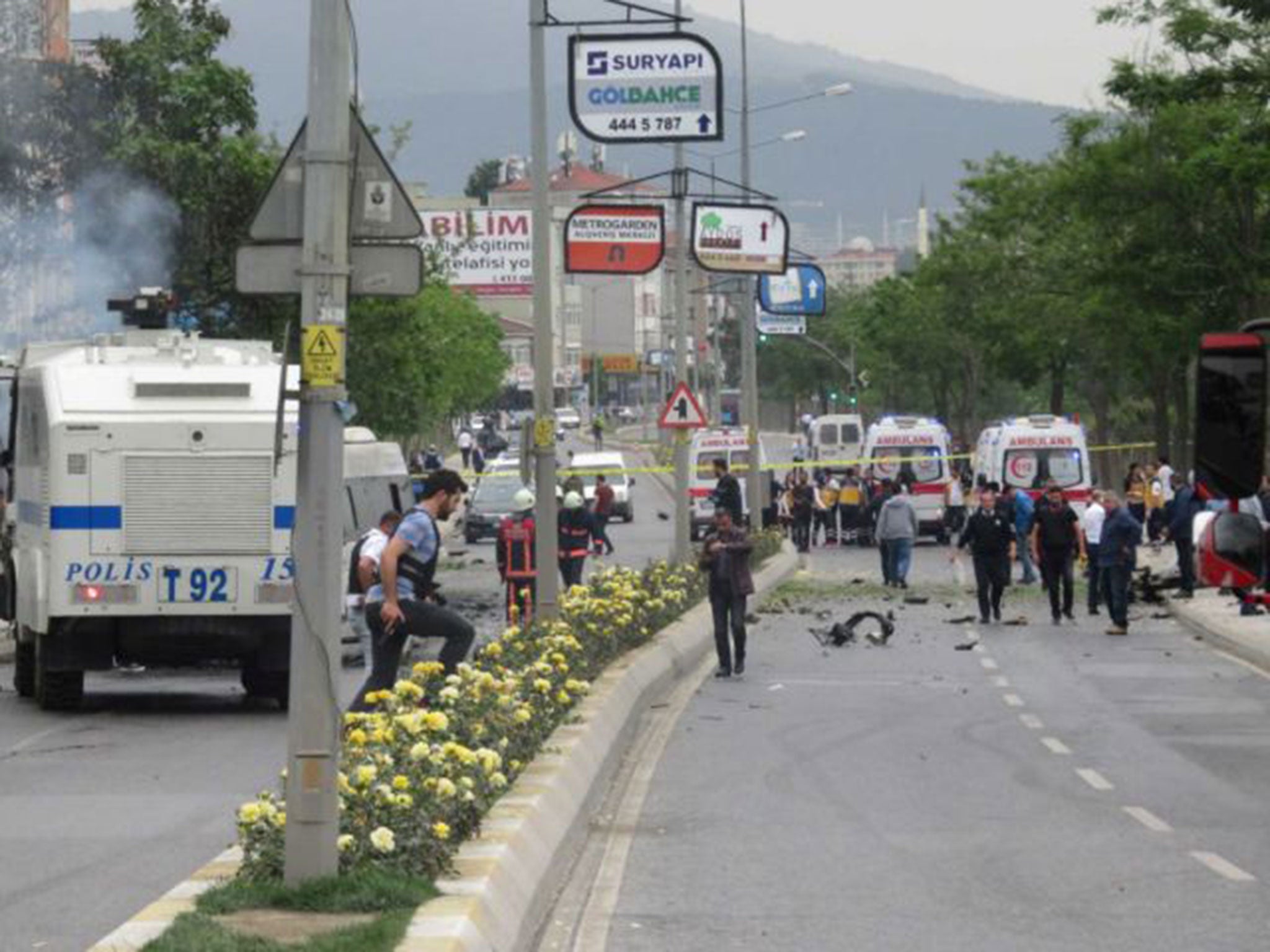 Security officers gather at the scene following a vehicle explosion near a military facility in Istanbul