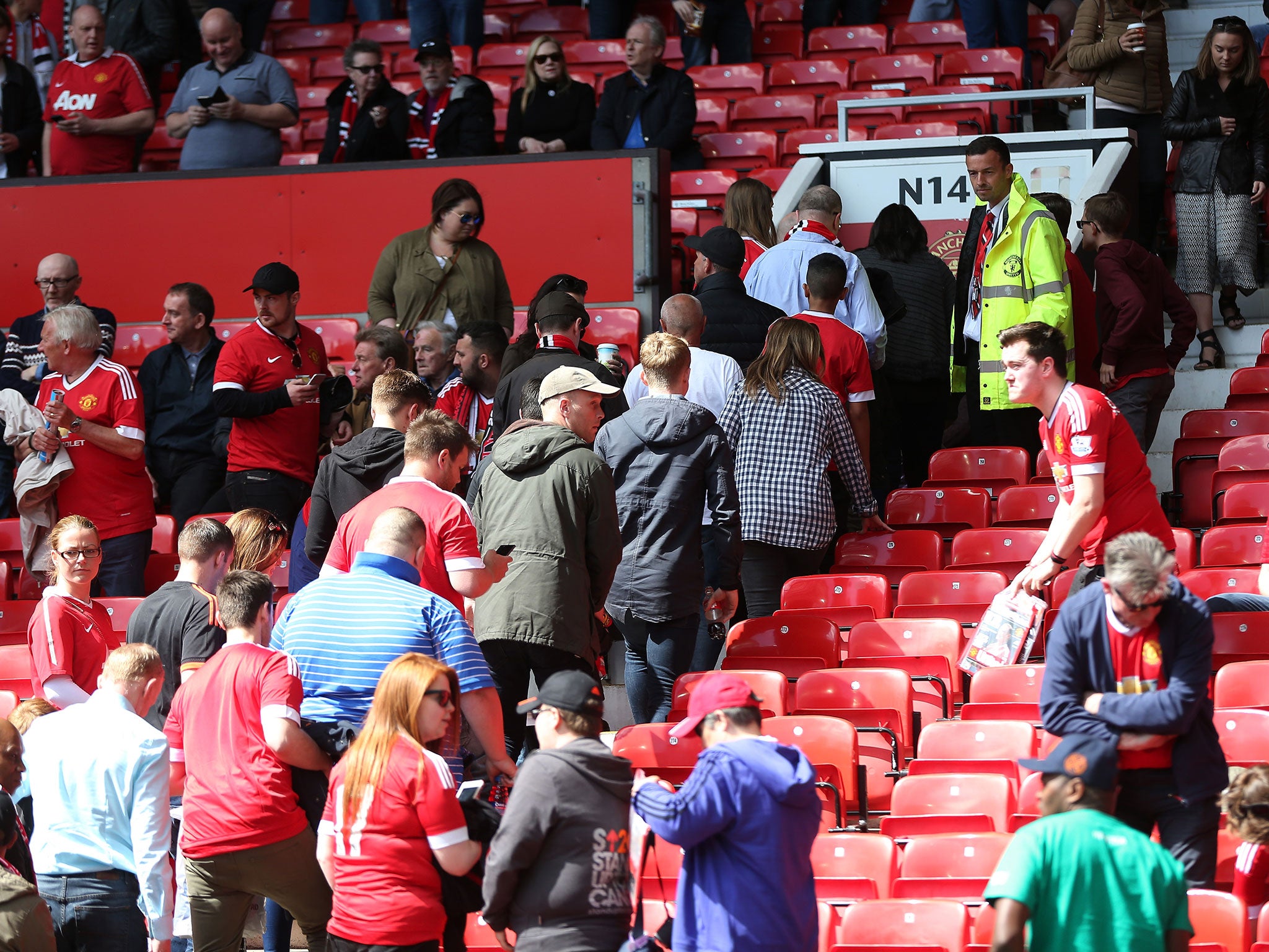 Manchester United fans leave the Old Trafford stadium