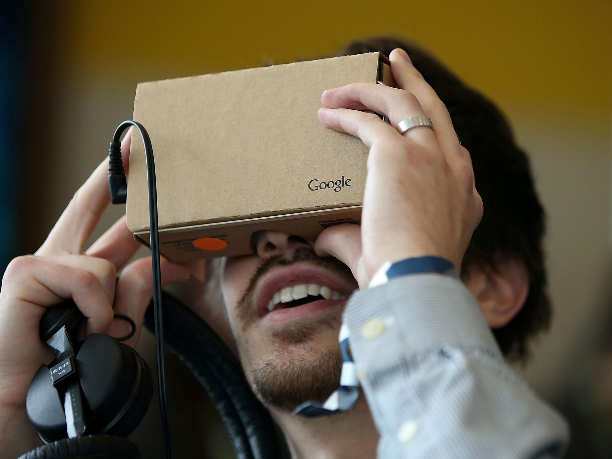 A man uses Google's Cardboard VR headset