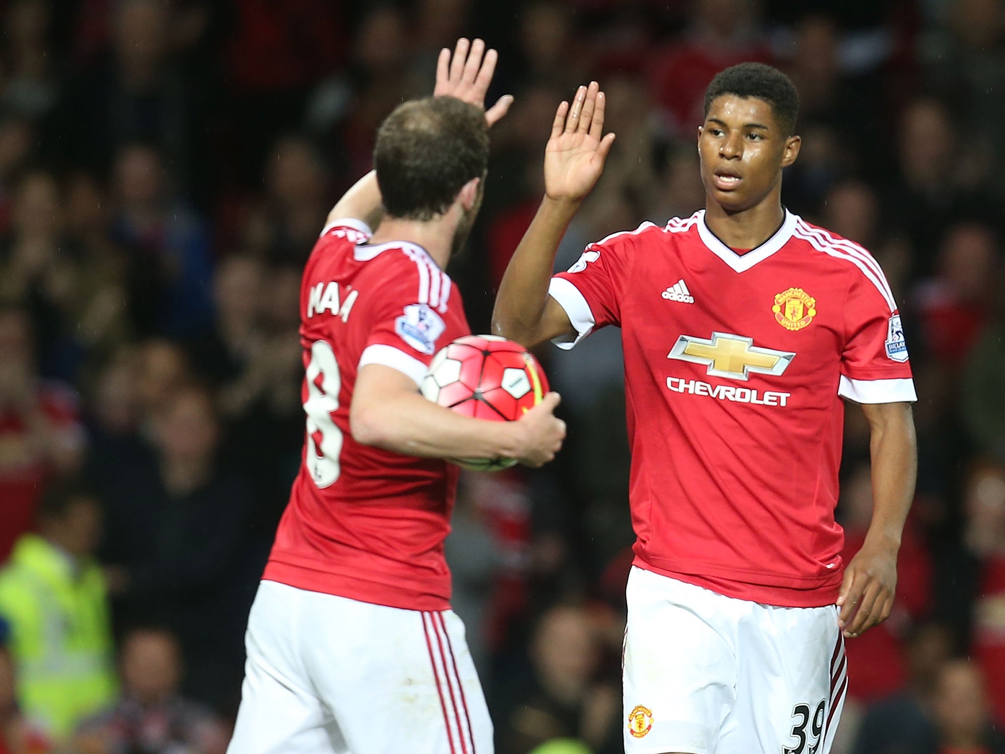 Marcus Rashford celebrates his goal with Juan Mata