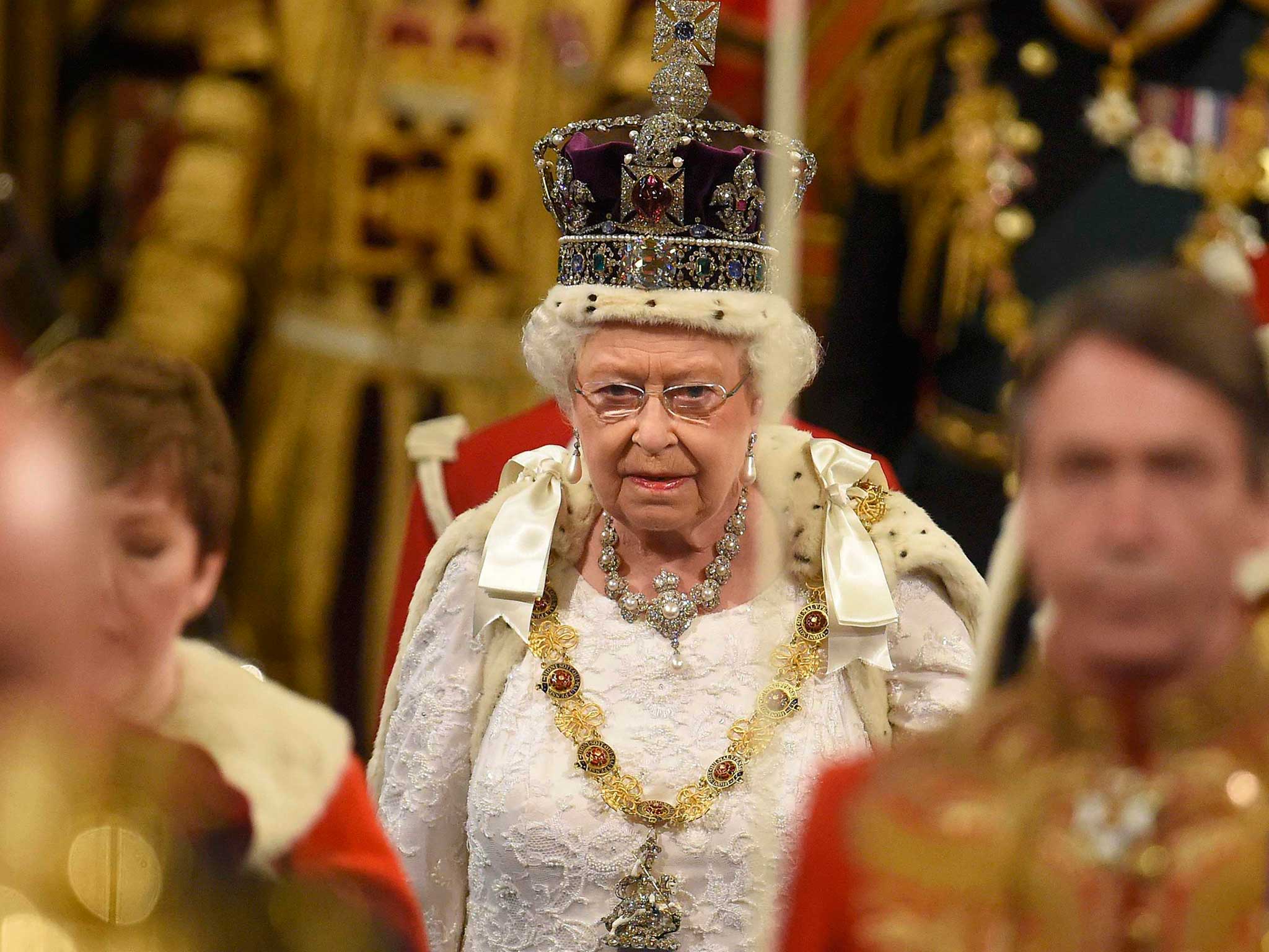 Queen Elizabeth II proceeds through the Royal Gallery before the State Opening of Parliament in the House of Lords