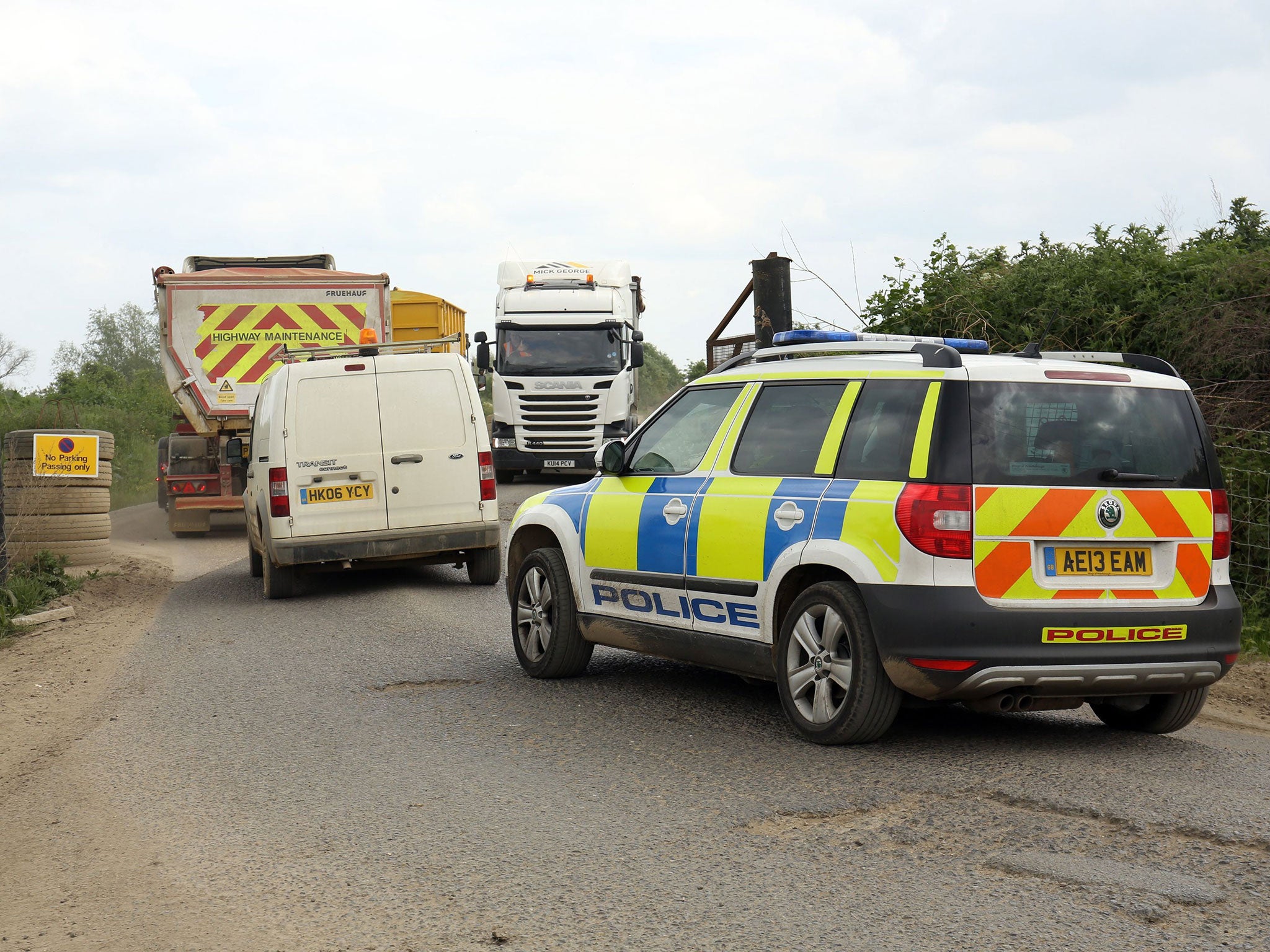 A police vehicle enters Block Fen Quarry at Mepal, near Ely, in Cambridgeshire, where a severed head was discovered on Monday.