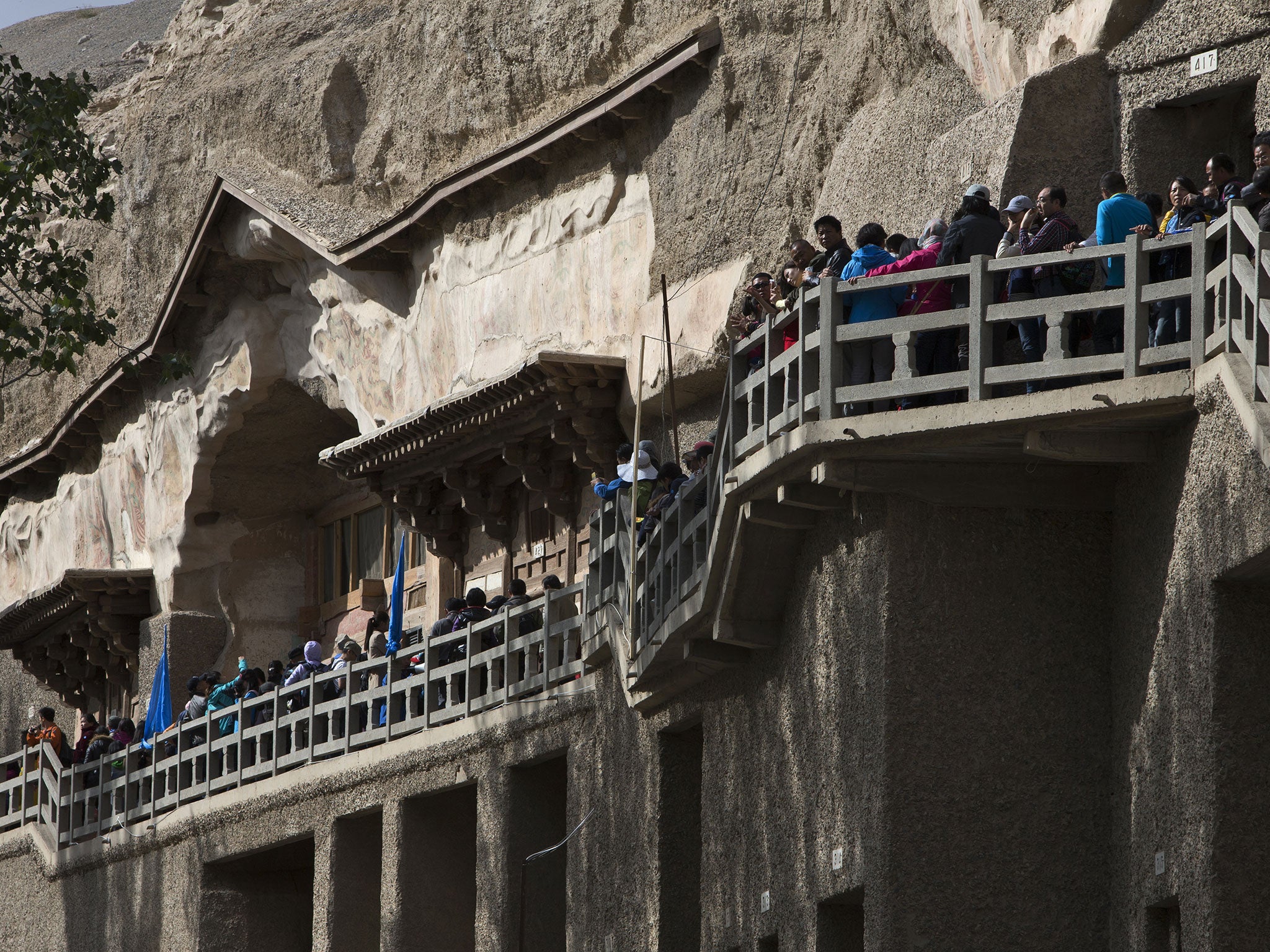 Tourists queue to enter the Mogao Grottoes during China's National Day holiday