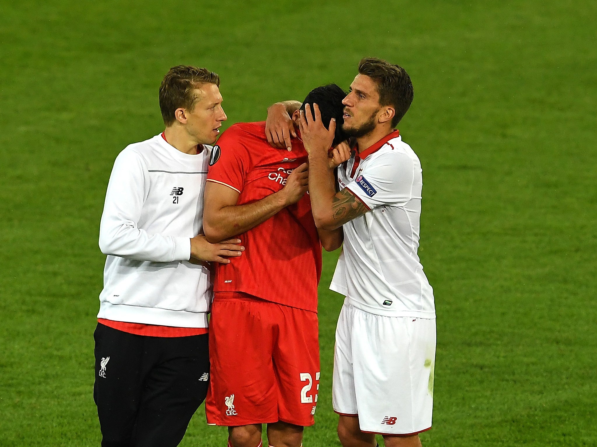 Emre Can, centre, is devastated at the final whistle