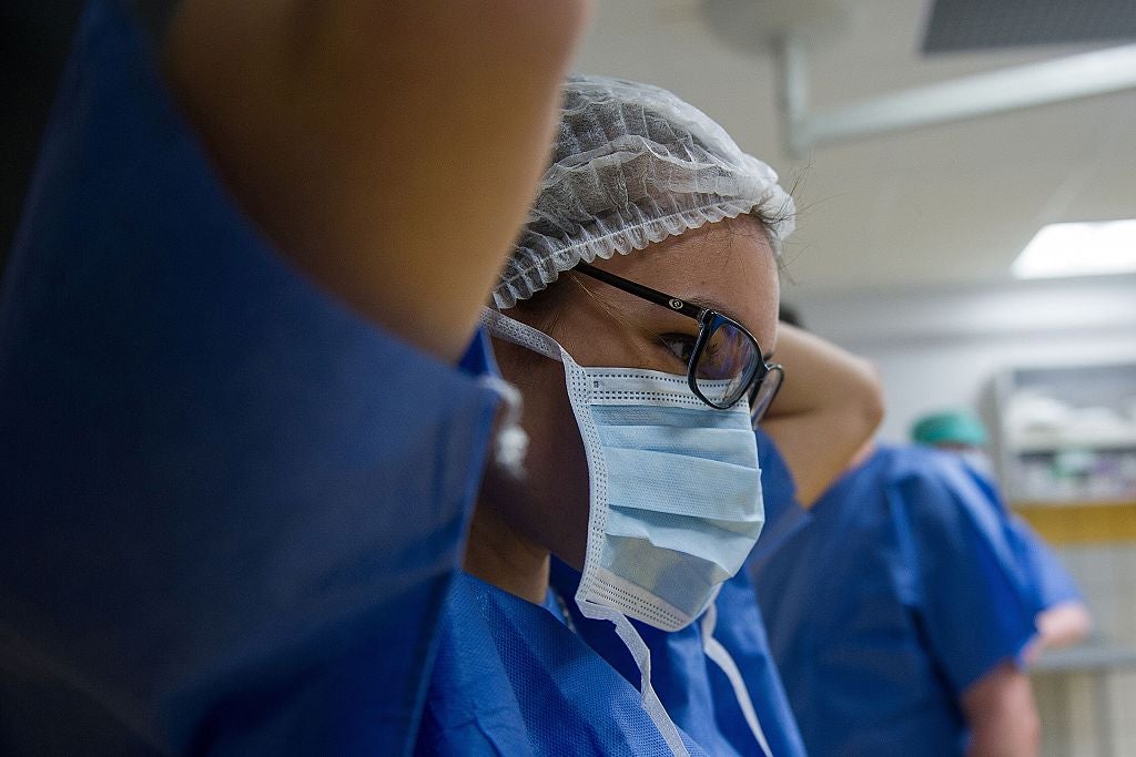 An intern prepares for practice surgery.