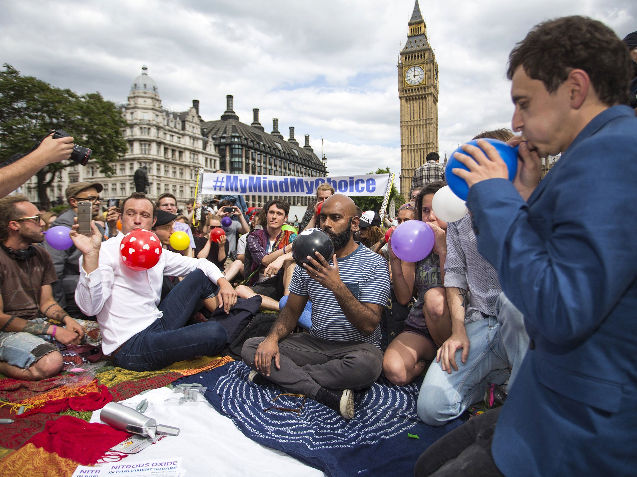 Protesters stage a mass inhalation of nitrous oxide in central London