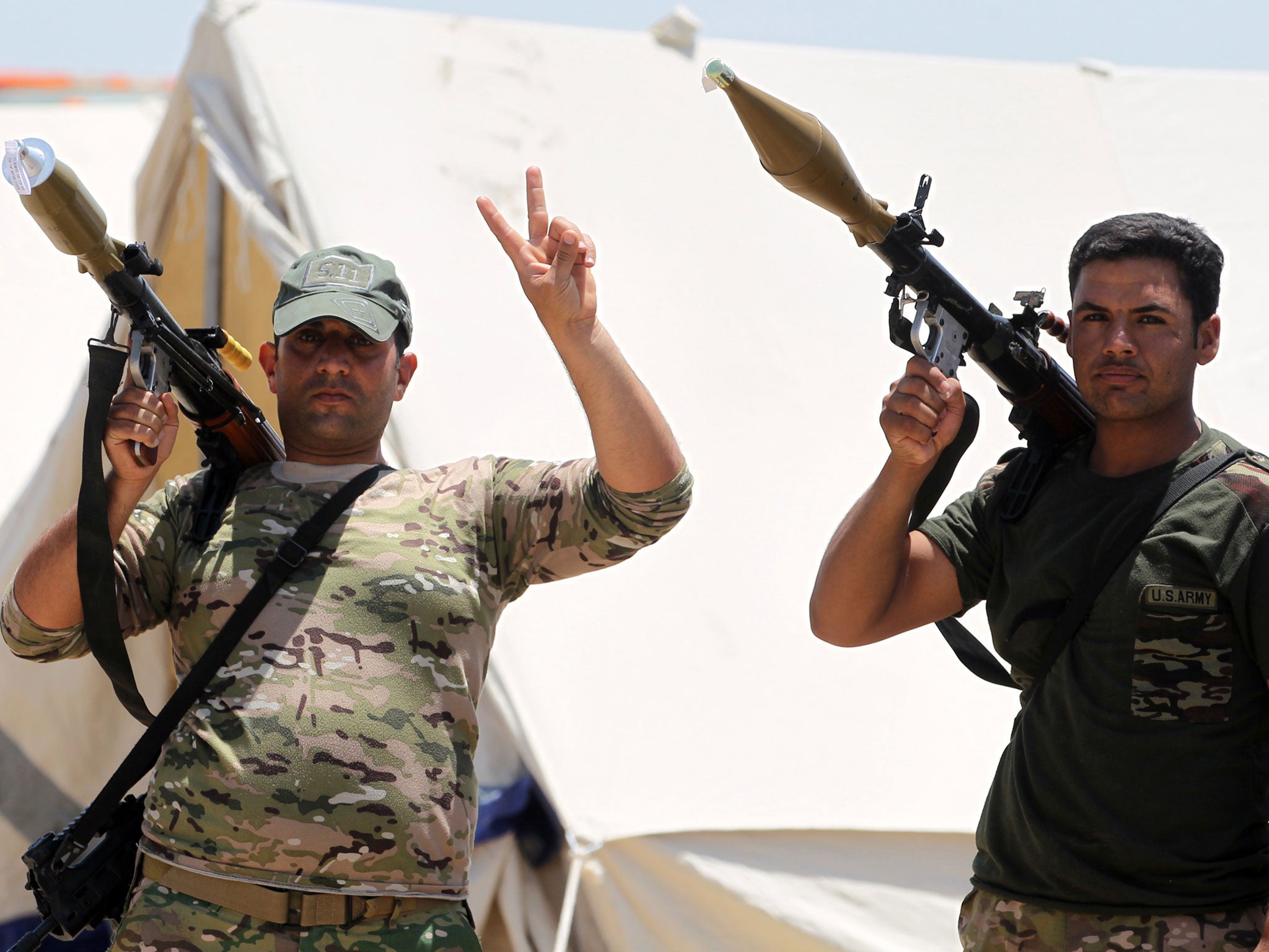 Members of the Iraqi security forces pose for a picture as they gather on the outskirts of Fallujah as they prepare an operation aimed at retaking the city from the Isis, 22 May, 2016