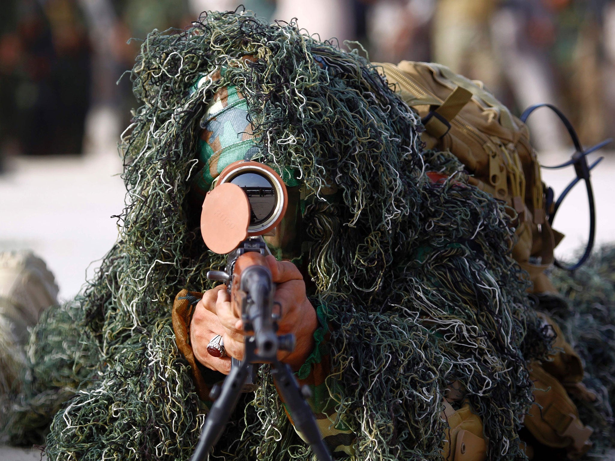 A member of the Shia Saraya al-Salam (Peace Brigades) aims with a sniper rifle in Iraq's holy city of Najaf as the paramilitary group prepare to reinforce government forces in the fight against Isis