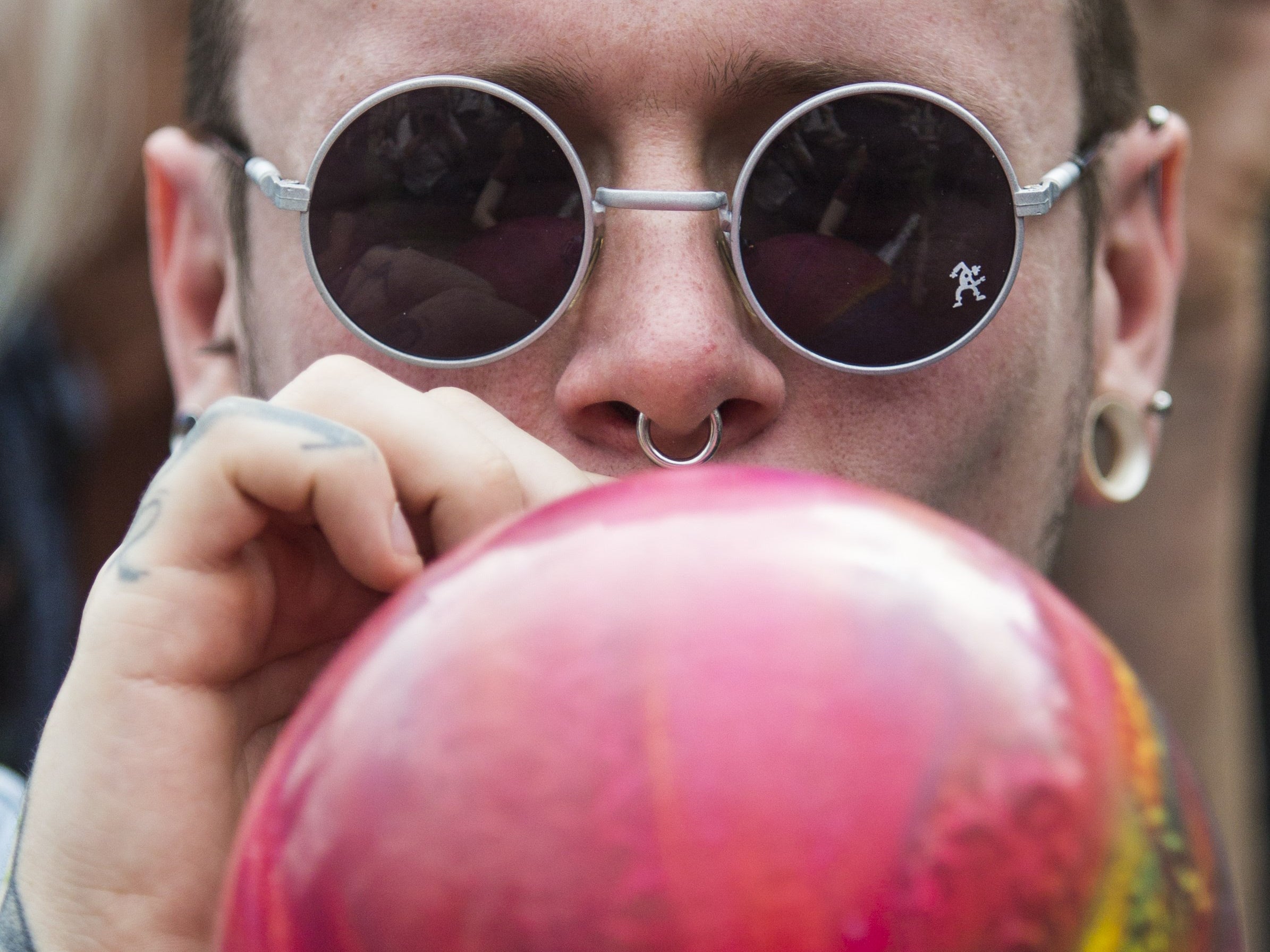 A protester inhales nitrous oxide parliament, research suggests the ban will not affect regular use of legal highs