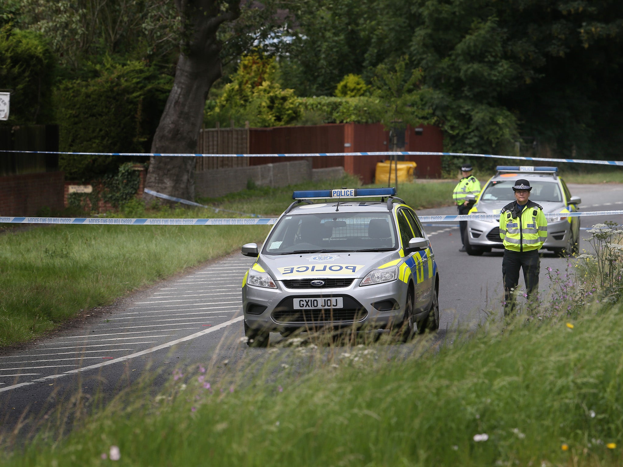 Police attend the scene of a murder on the A24 road in Findon, West Sussex