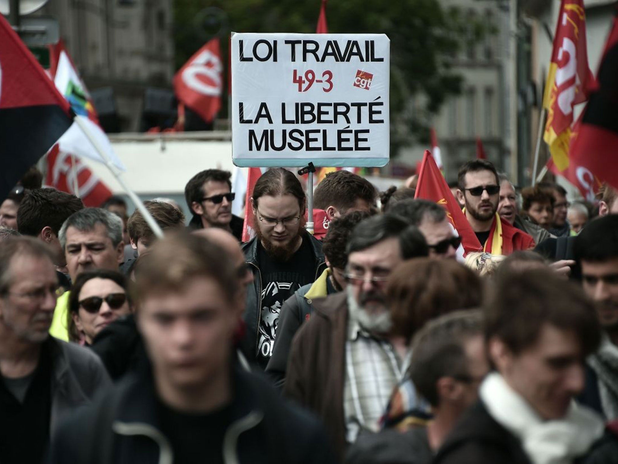 Demonstrators take part in a protest and hold a placard reading "Labour reform, muzzled freedom" against the government's planned labour law reforms in Strasbourg, eastern France