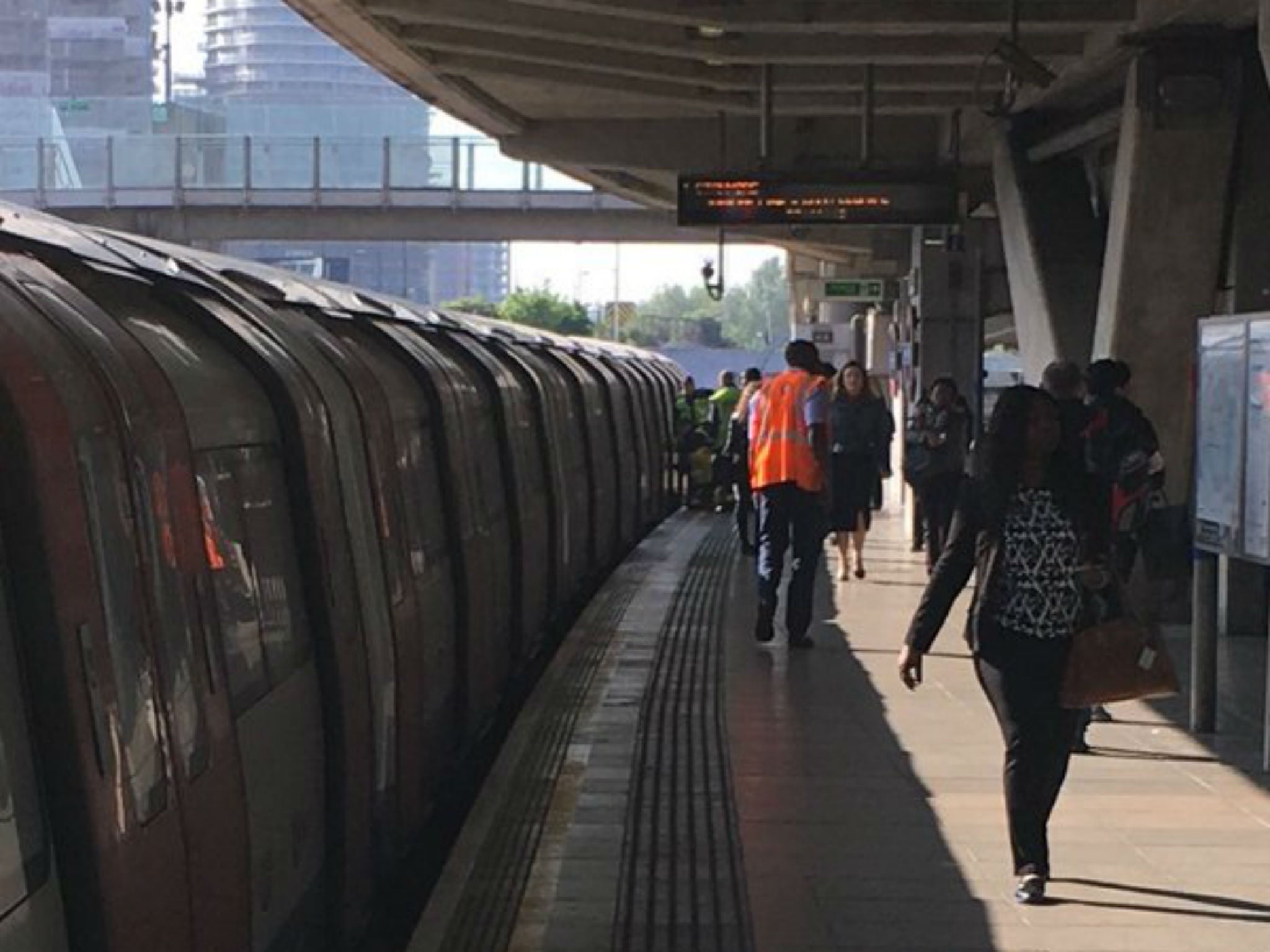 Canning Town station was evacuated after a woman's leg became trapped between a Tube train and the platform on 26 May