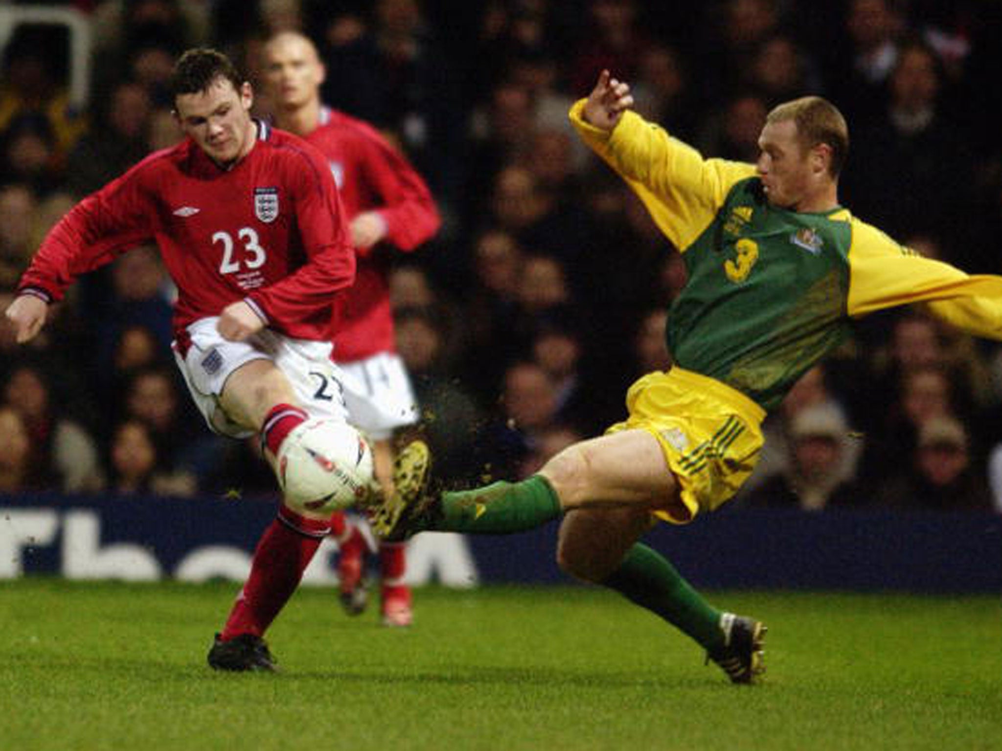 Rooney is closed down by Australia defender Craig Moore as he makes his England debut at Upton Park 13 years ago (Getty)