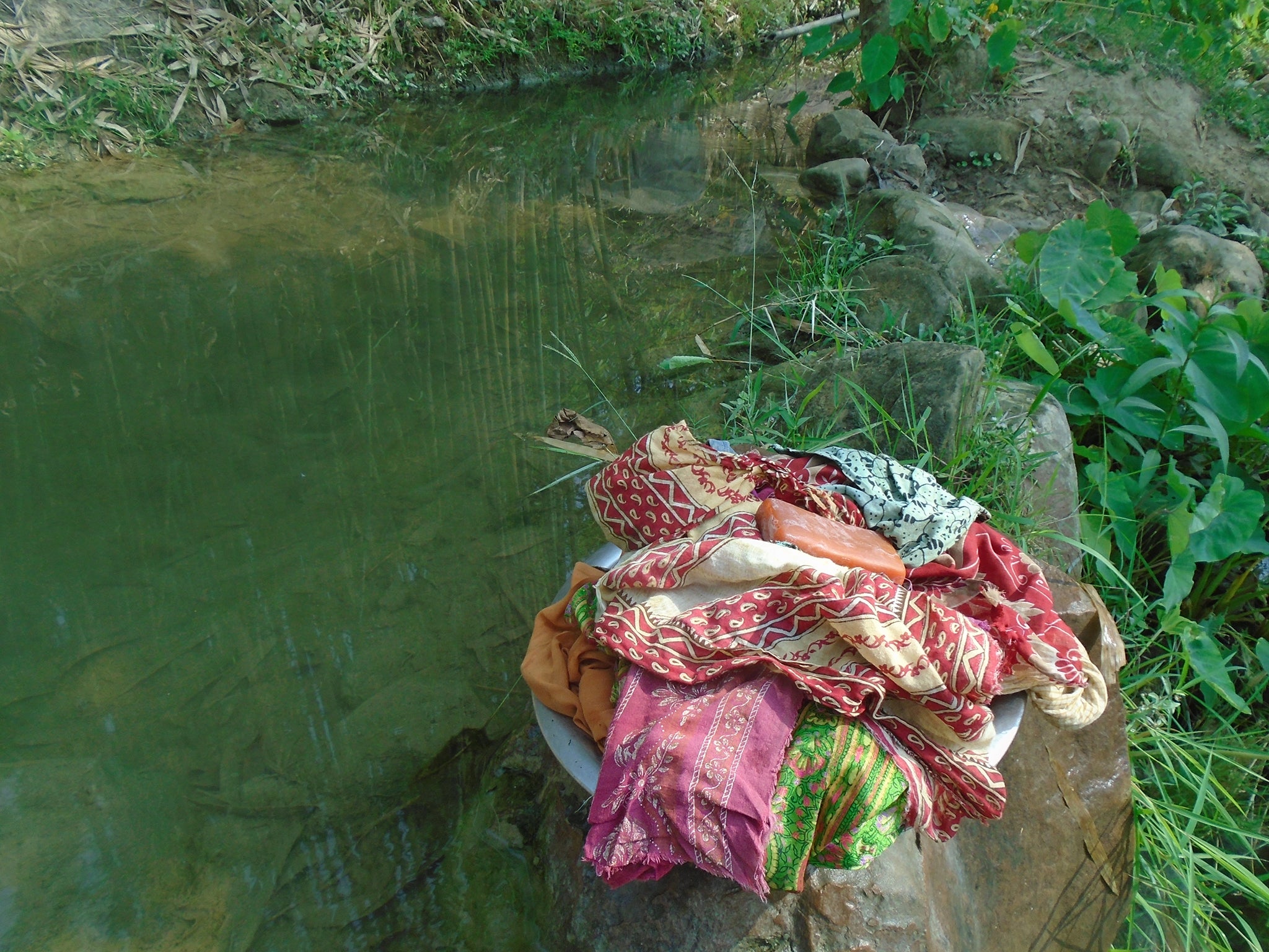 Manisha Karki, 15: "This is the picture of the stream where I bath and clean my pads. In this picture there is a stack of pads that I use and I clicked this picture sometime before I started washing them. During our menstrual cycle it’s very embarrassing for us to wash our used pads out in the public place hence, we find nearest corners and isolated streams to clean our pads and wash ourselves."