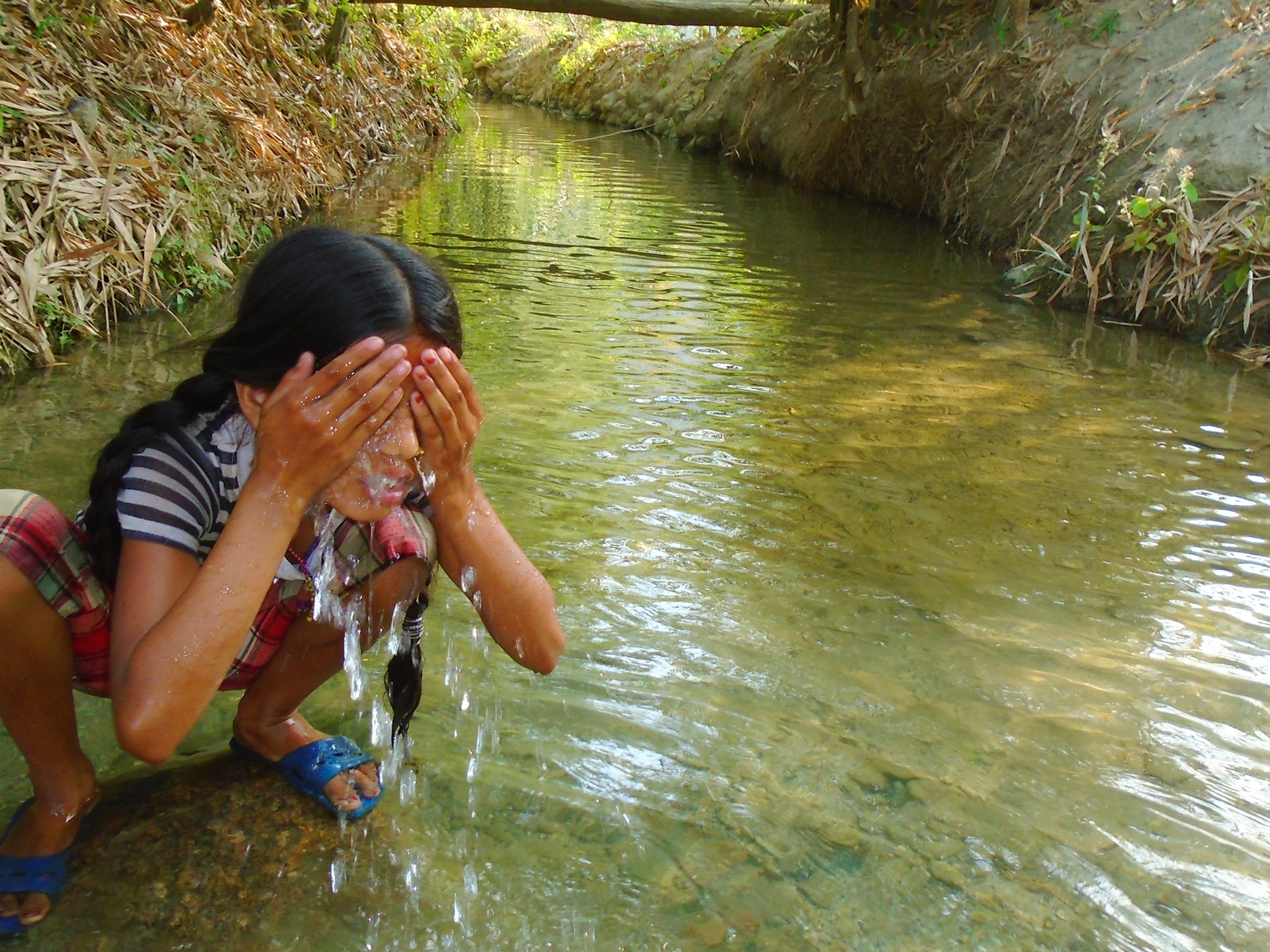 Bisheshta Bhandari, 15: "The place featured in the picture is the place where I used to wash myself during my first menstruation. My sister Shristi is washing her face in this picture. When I had my first menstruation, I stayed at another's house, as we were not allowed to stay in our own house. The house where I stayed during my first menstruation is 15 minutes away from my own house. We teenage girls are more secure with our own parents, be it during menstruation or not. Moreover during menstruation, we need extra care and support from our parents. When we have to stay out of home in some other house for seven days, we may not be secure. Therefore any adolescent girls need to stay with their parents to be safe and secure.