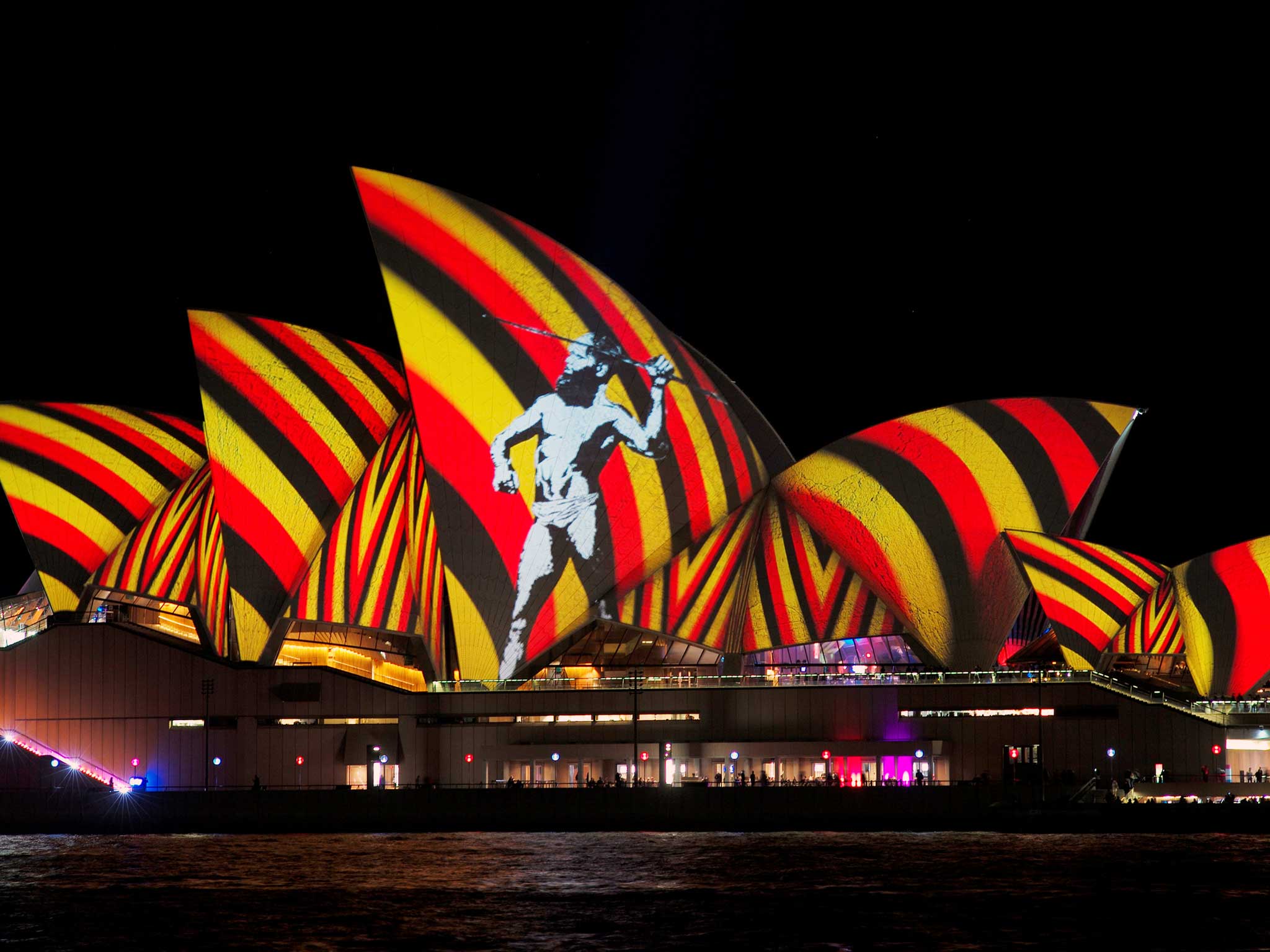 An image of an indigenous Australian man is projected onto the sails of the Sydney Opera House during the opening night of the annual Vivid Sydney light festival in Sydney