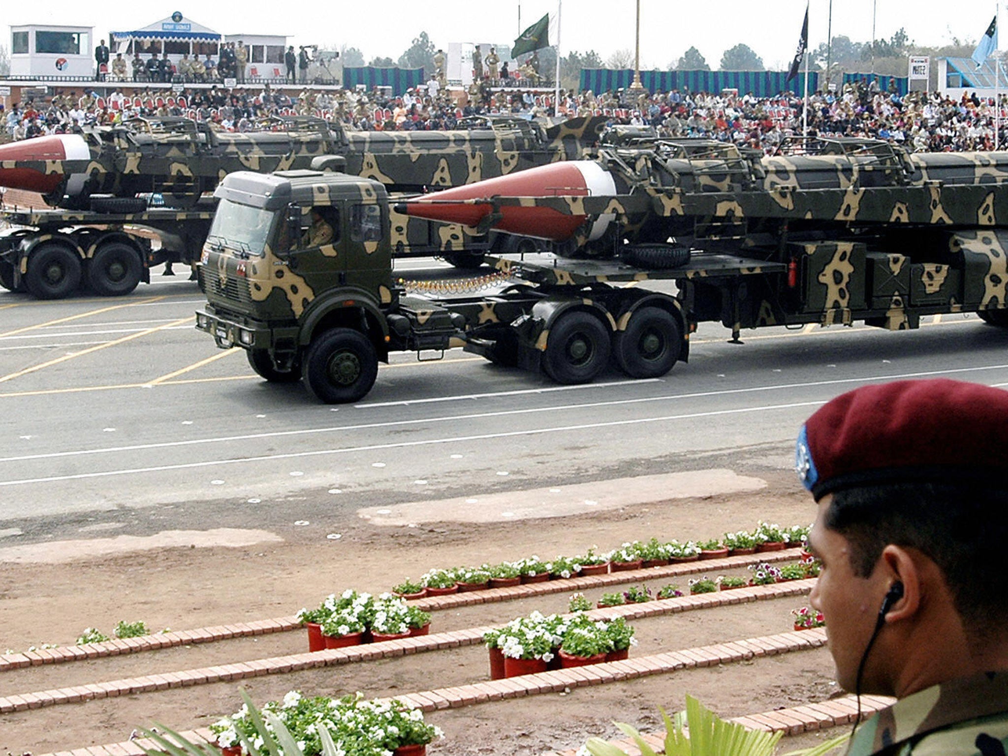 A Pakistani commando looks on as Ghauri intermediate-range missiles capable of carrying nuclear warhead are transported on launchers during the National Day parade in Islamabad, 23 March, 2005