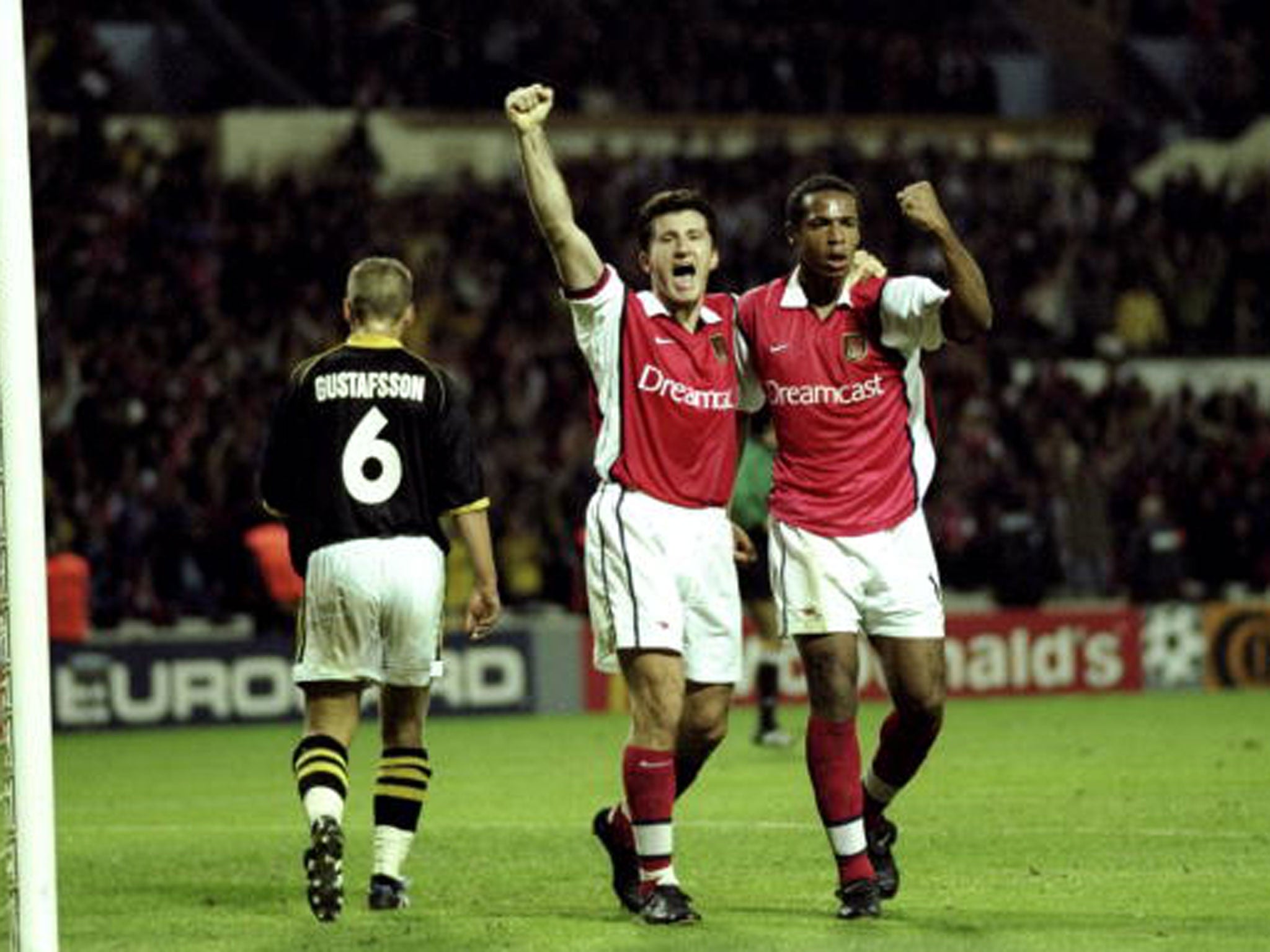 Scorers Davor Suker and Thierry Henry celebrate as Arsenal beat AIK Solna in 1999 (Getty)