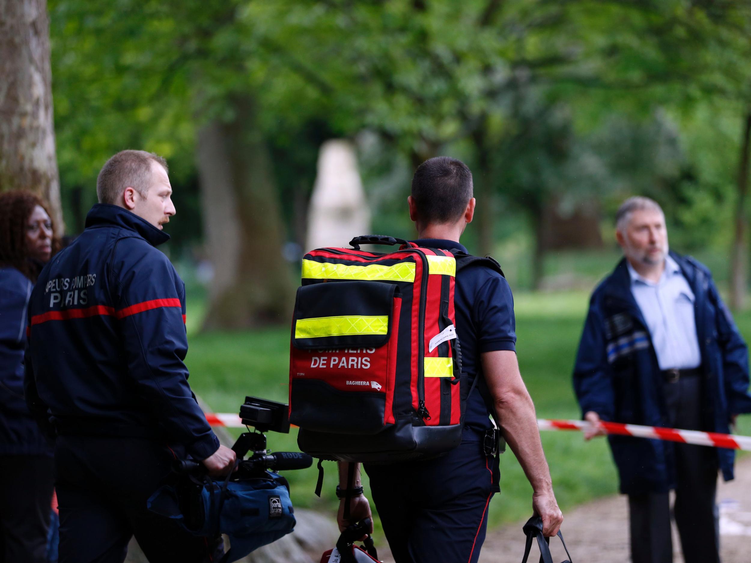 Firefighters attend Parc Monceau on May 28, 2016 in Paris, after eleven people including 10 children were struck by lightning in the park