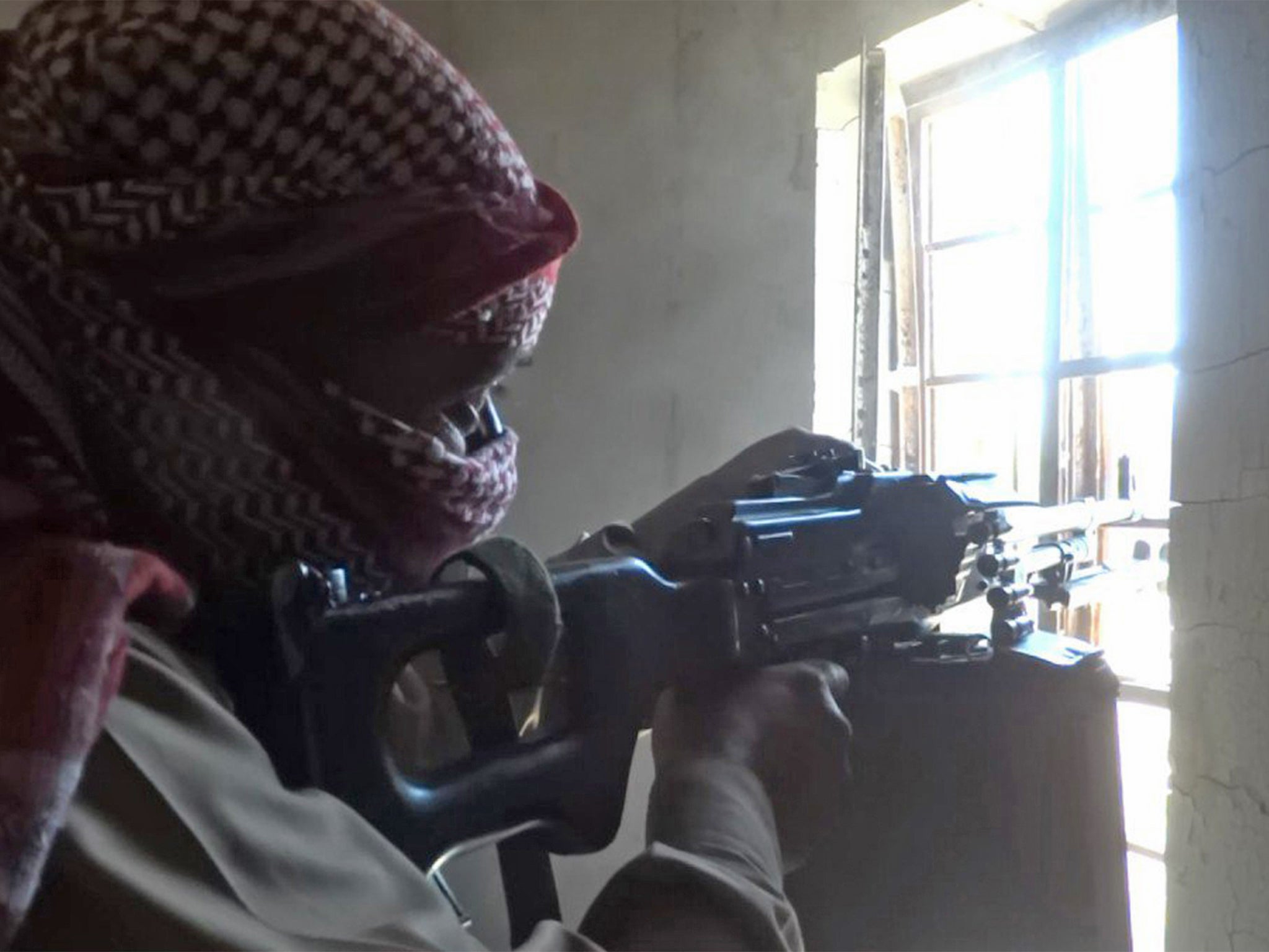 An Isis fighter takes aim during battle with Iraqi forces near Fallujah