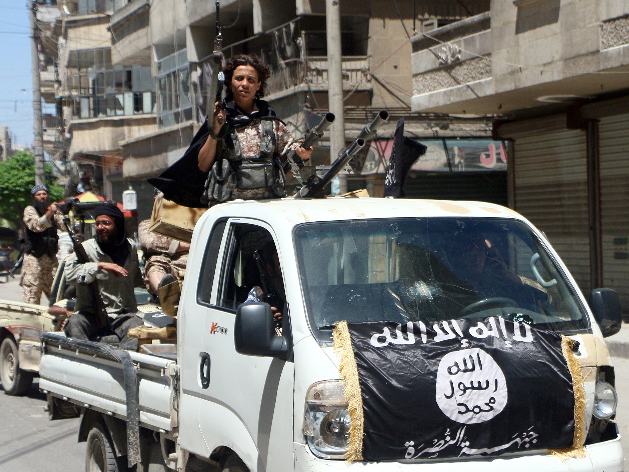 Jabhat al-Nusra fighters parading through Aleppo last year