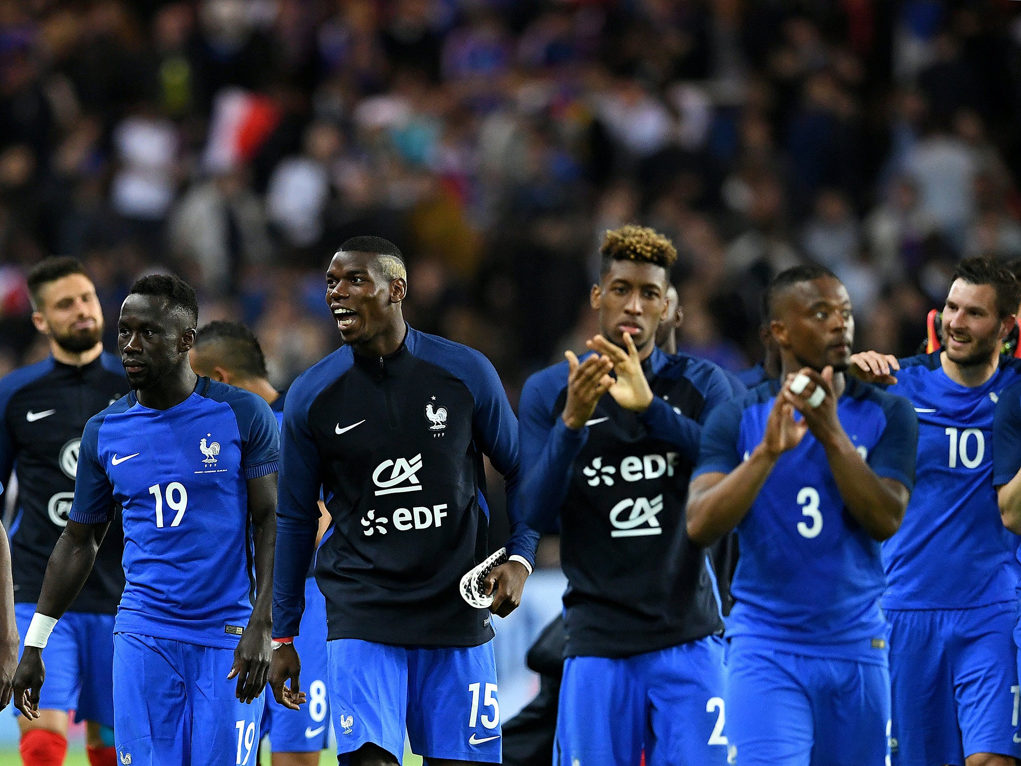 France's players walk off the pitch following victory over Cameroon on Monday