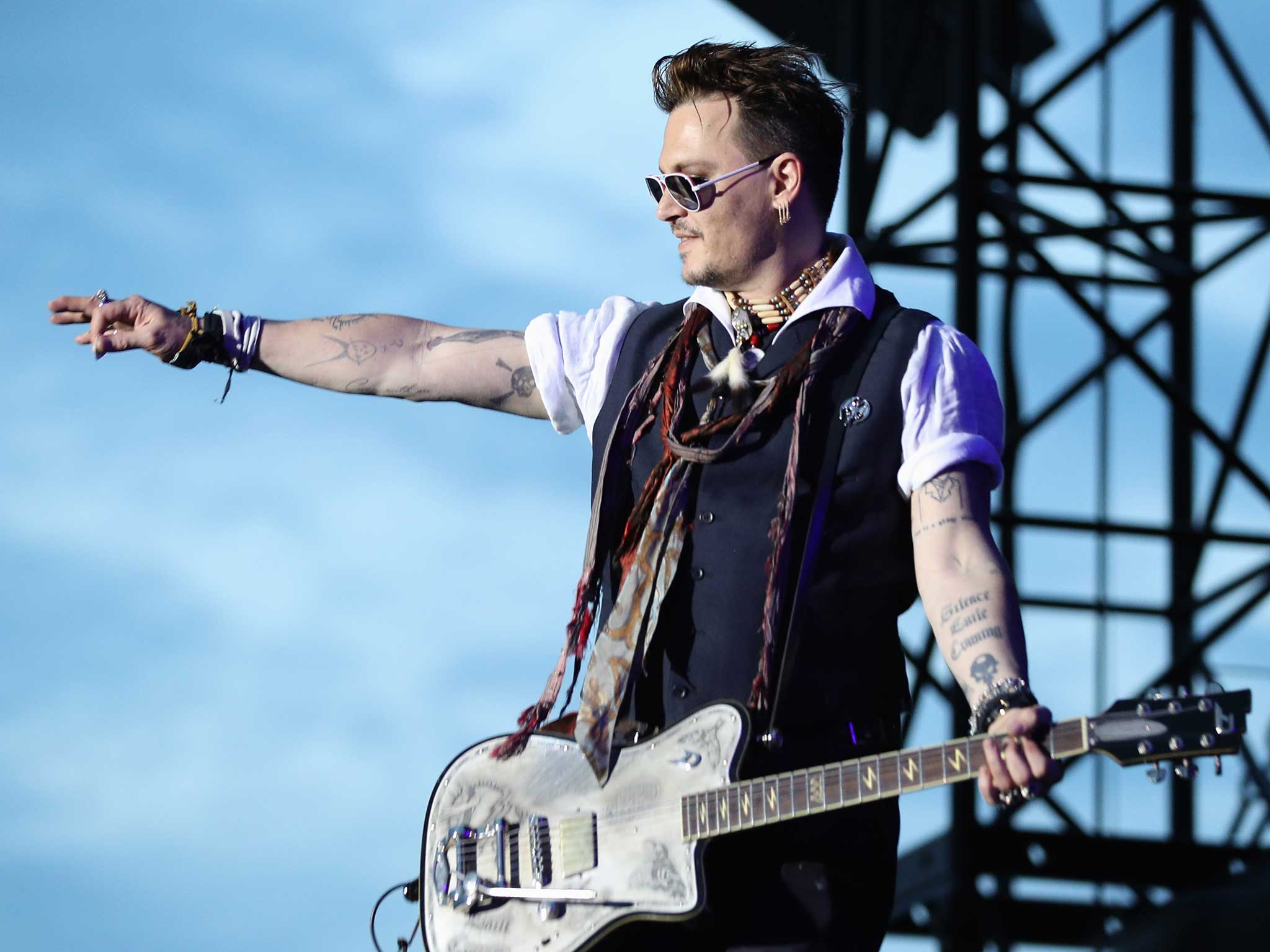 Johnny Depp performing with his band in Germany