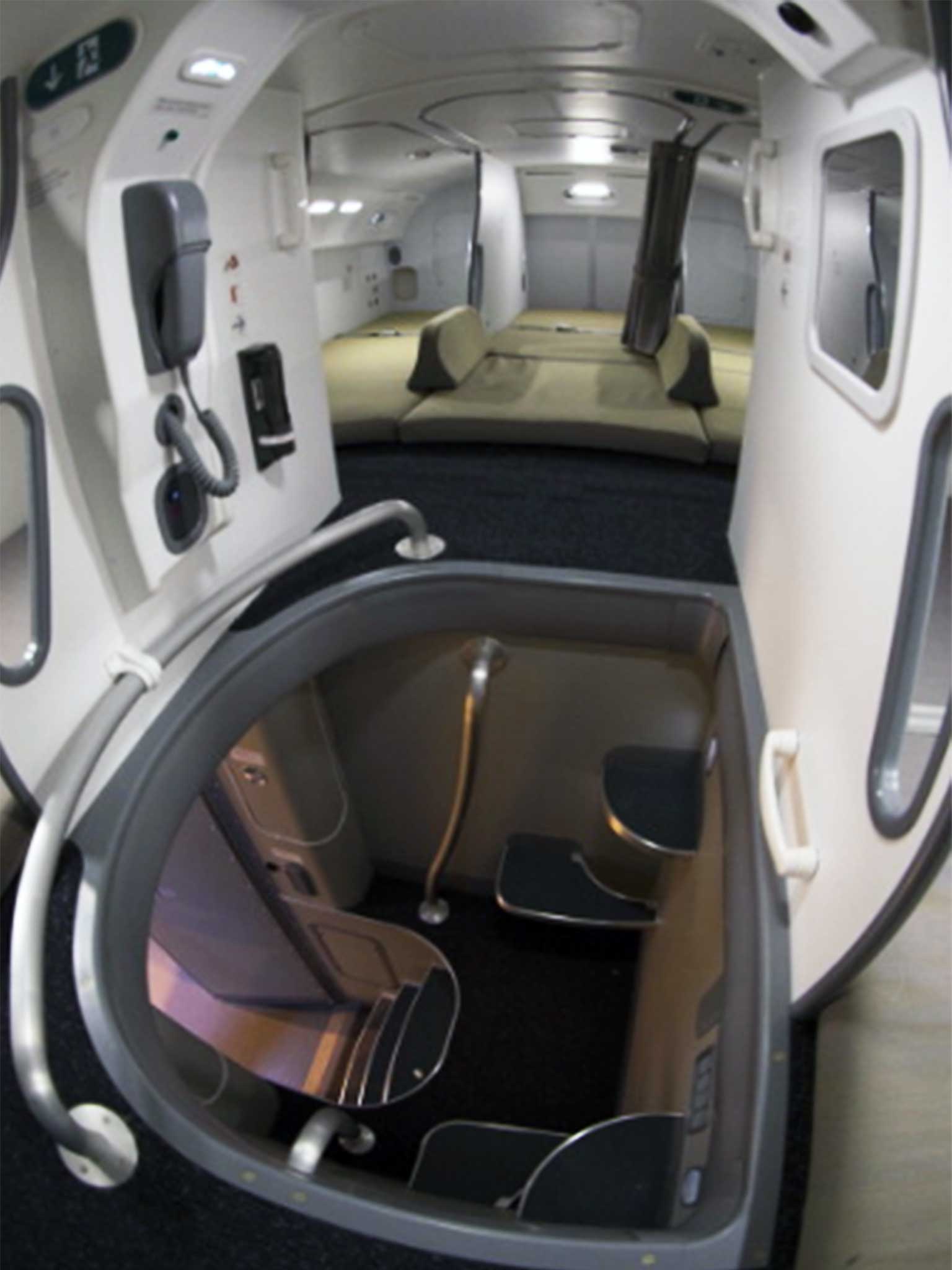 A small stair case leads to a compartment of sleeping berths for long haul crew members in Boeing 787 Dreamliner (Getty )