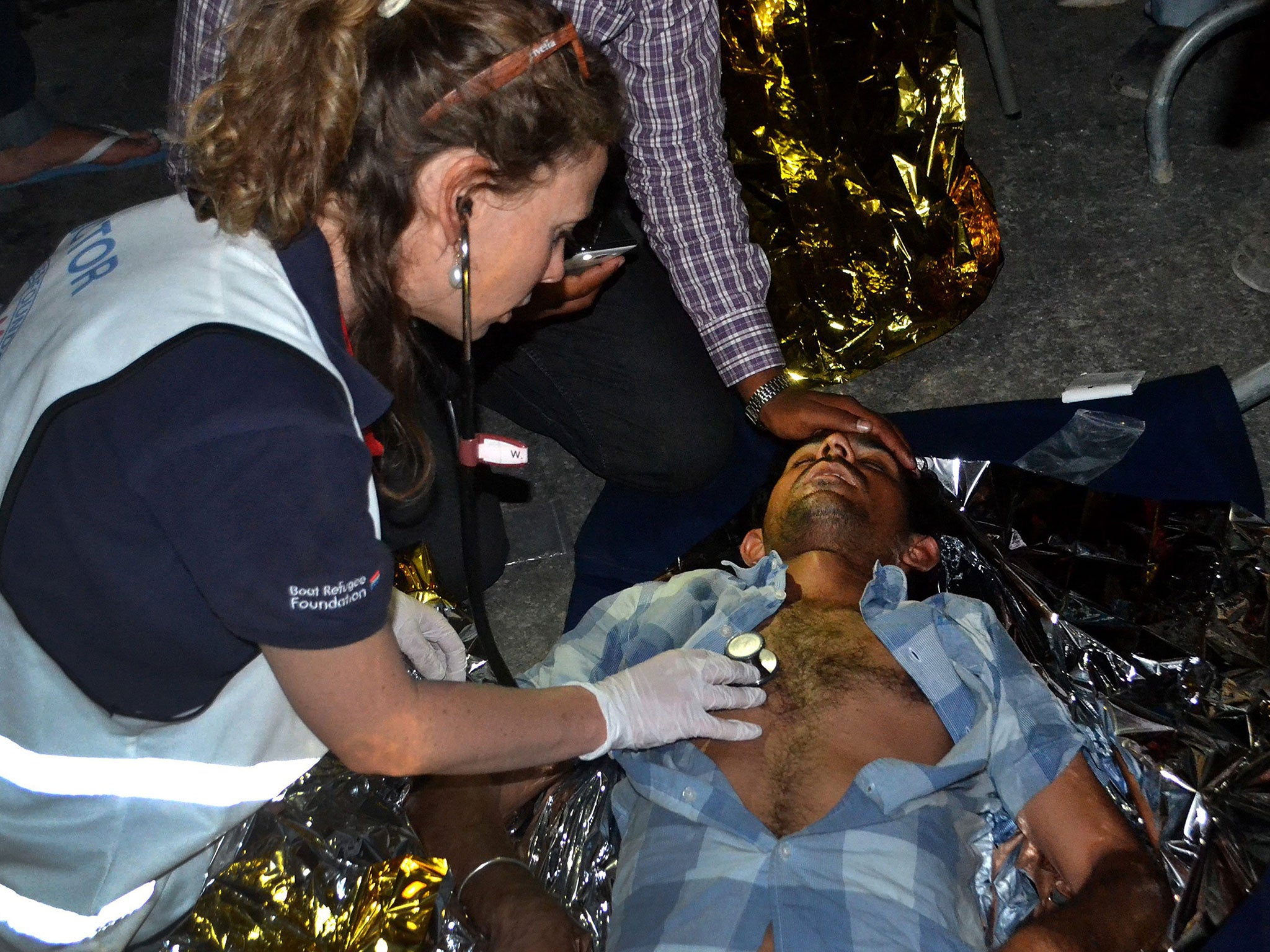 An injured man receives first aid after clashes at Moria detention centre in Lesbos, Greece, on 2 June 2016.