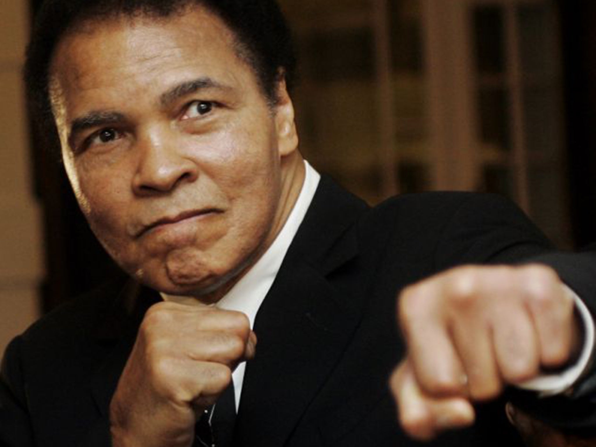 Muhammad Ali poses during the Crystal Award ceremony at the World Economic Forum (WEF) in Davos, 2006