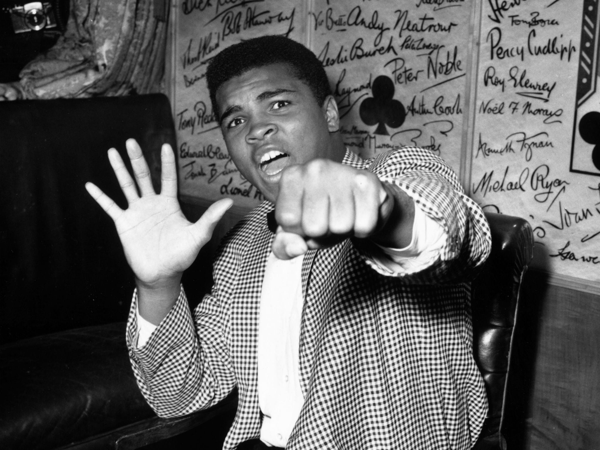 Ali in 1963: five fingers to represent how many rounds he said it would take him to beat British boxer Henry Cooper