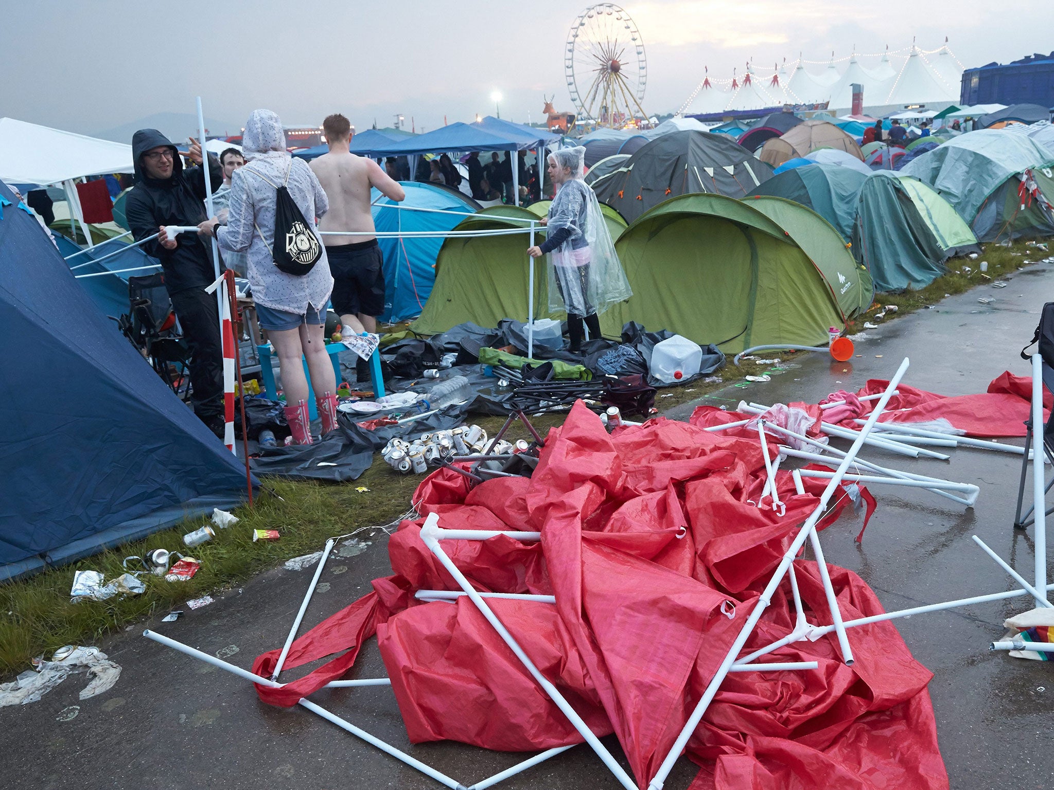 People reassemble a tent after the venue of the festival 'Rock am Ring' was hit by a storm in Mendig, Germany, 03 June 2016